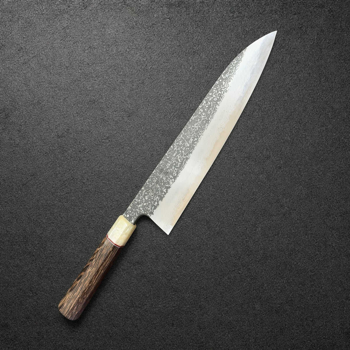 Masuda Blue 1 Kurozome Damascus Gyuto 240mm with Prisma wenge handle and pale faux ferrule, angled engraved-side view