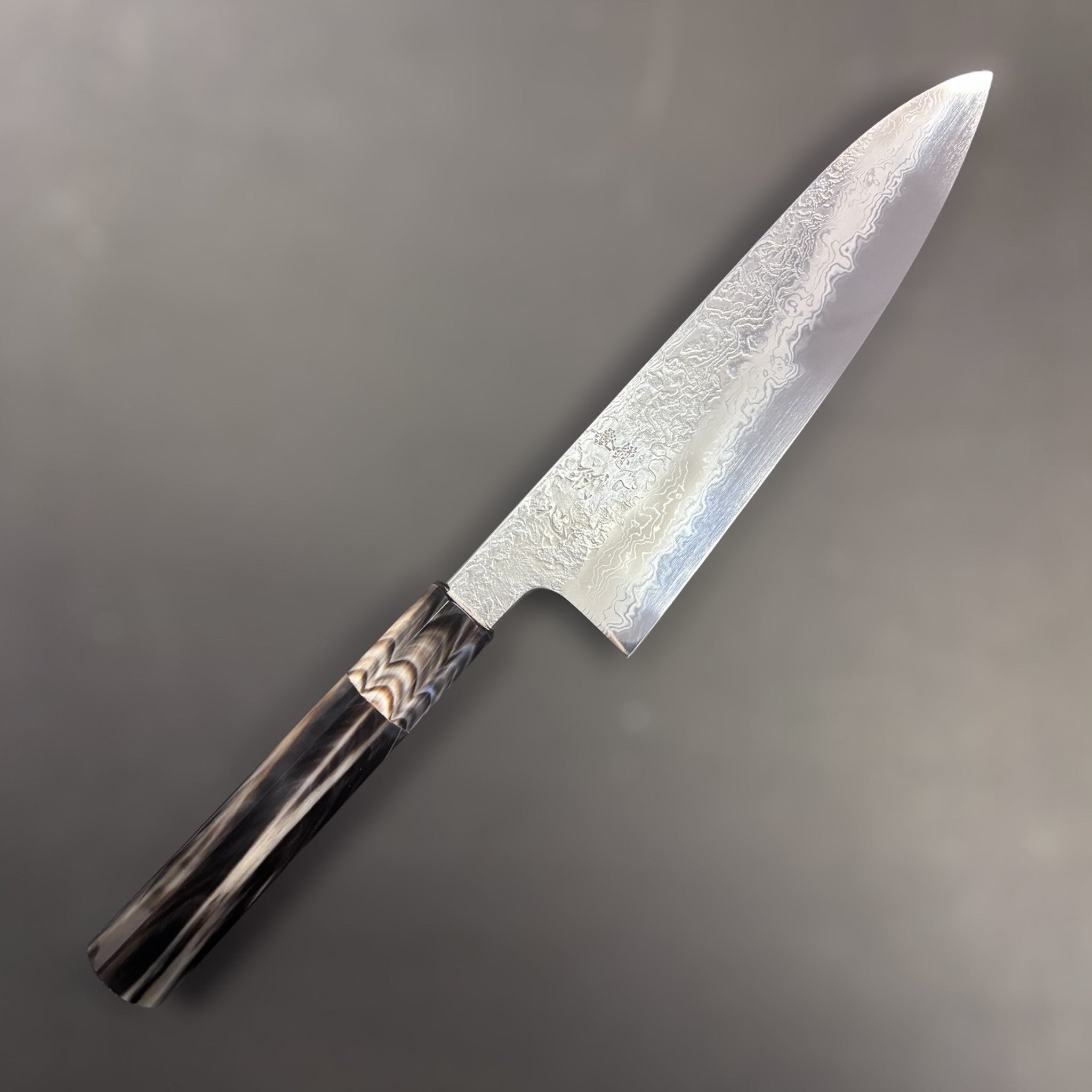 Masuda Yoshihide Blue #1 Damascus Gyuto 190 mm, primary face highlighting swirling Damascus pattern.