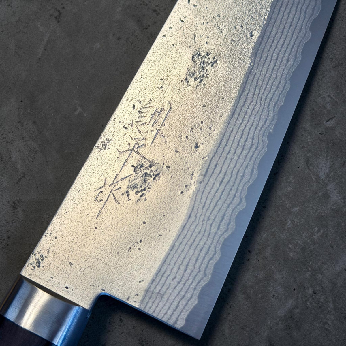 Masutani Sekka VG10 Santoku blade close-up showing nashiji finish, layered cladding and kanji