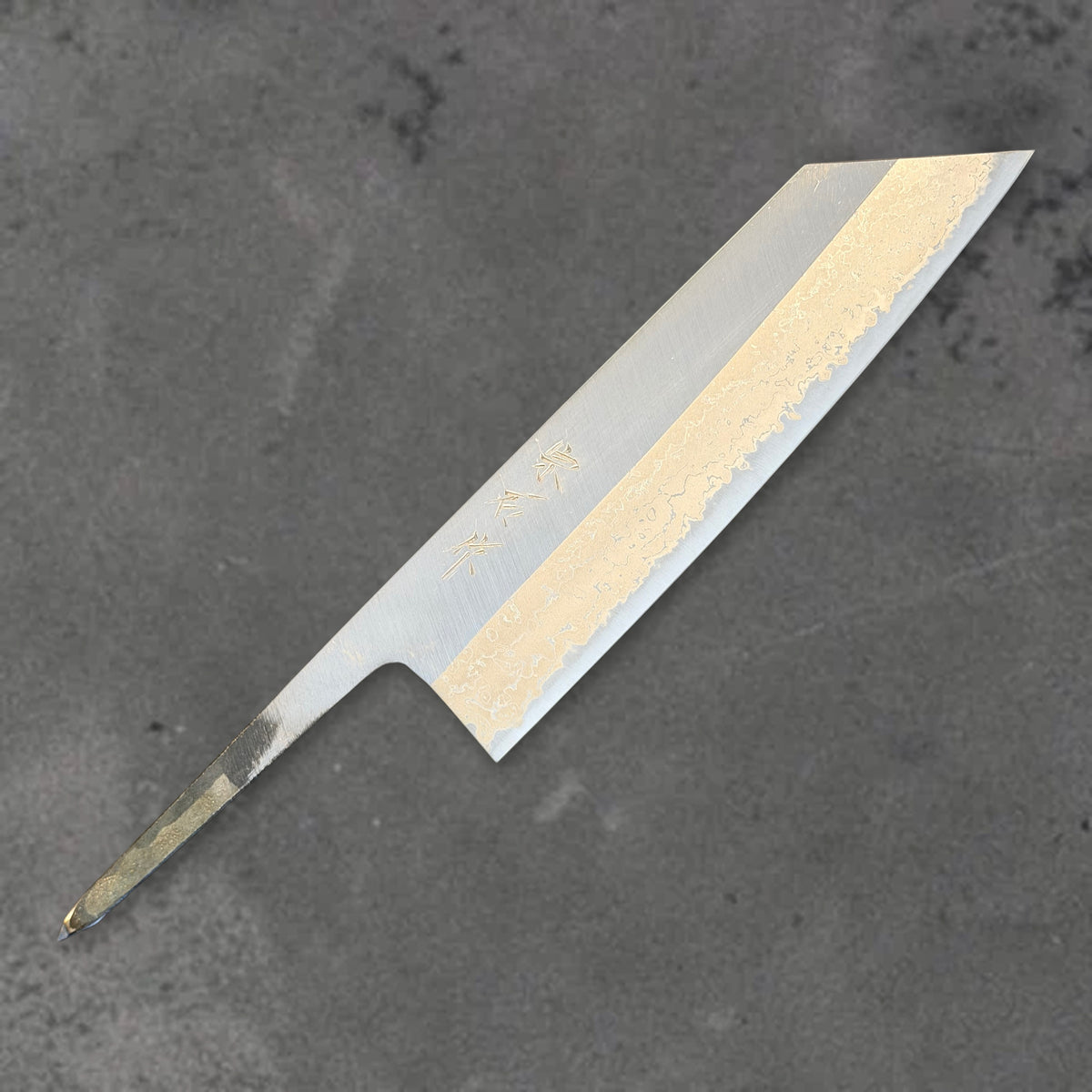 Angled front view of the Muneishi Blue #2 Damascus 165mm bunka blade, showing its pointed tip, Damascus pattern, and exposed tang.