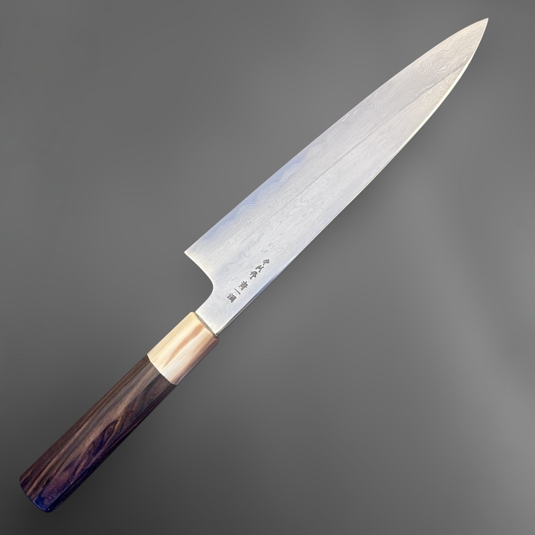 Nakagawa Satoshi Blue #1 Damascus Gyuto 225 mm with ebony and horn handle, angled full-length product view.