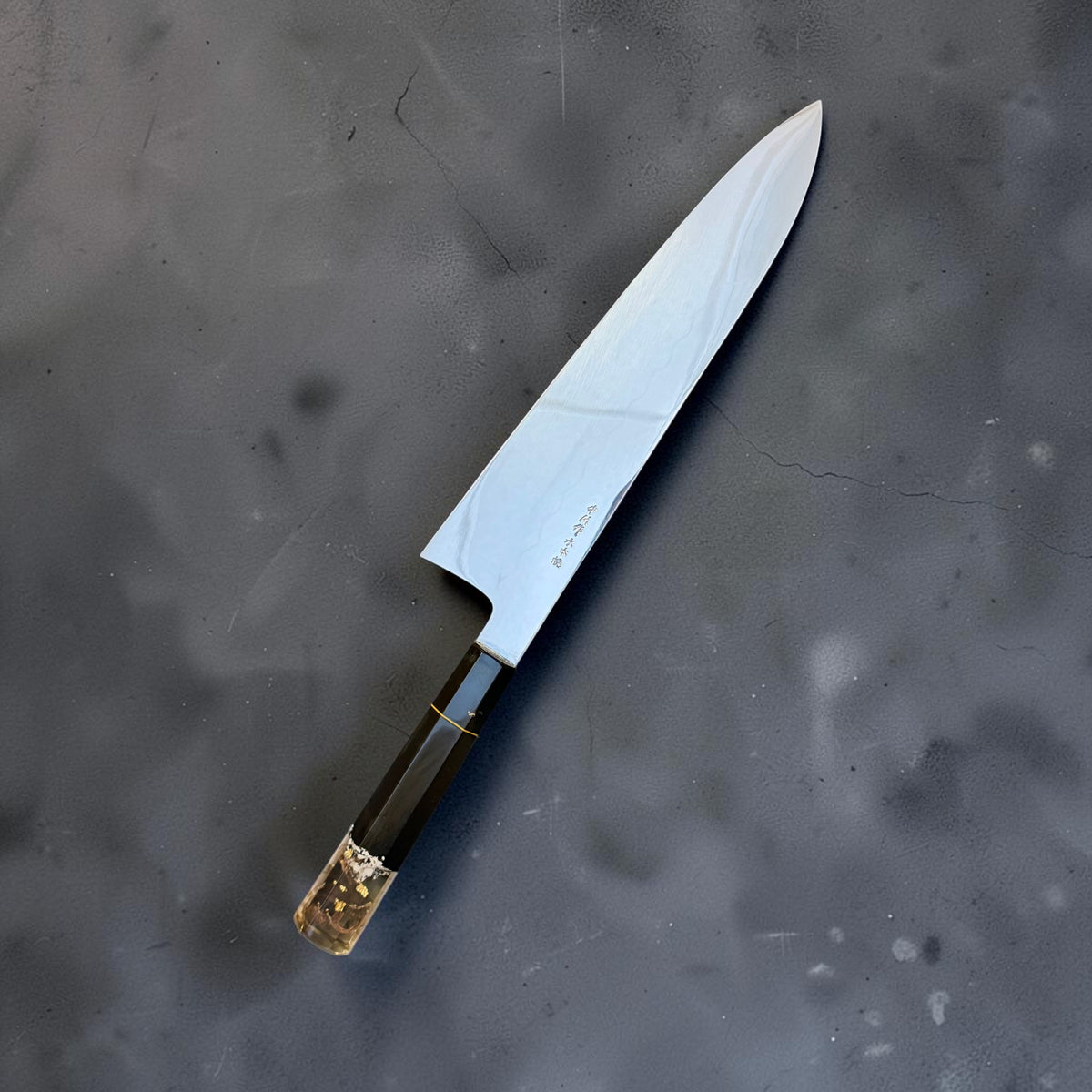 Nakagawa × Tokushu White #2 honyaki gyuto 255mm with black Prisma handle, polished blade and gold-accented clear butt