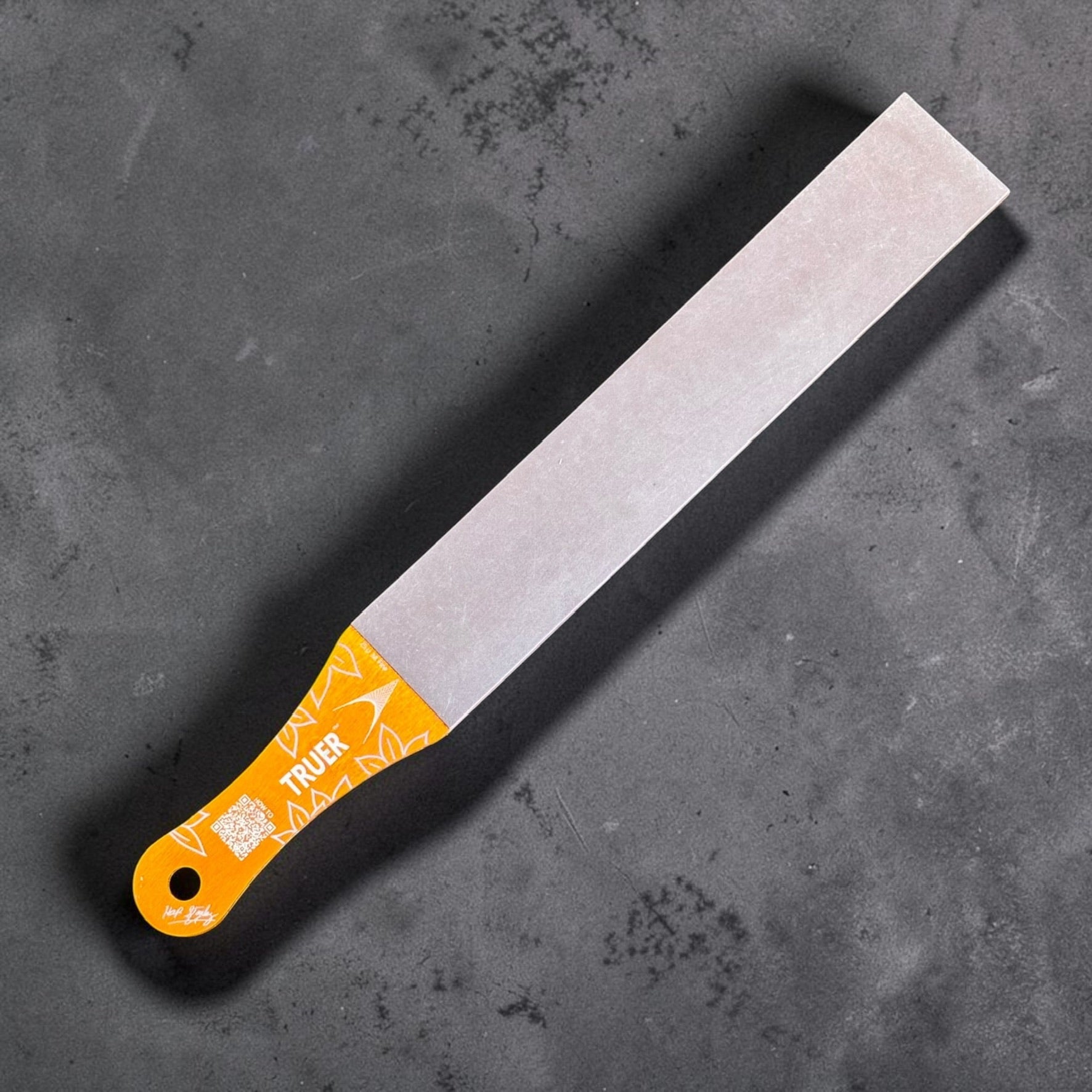Nano Hone Truer 25/100 paddle strop showing the 25 micron fine diamond resin side