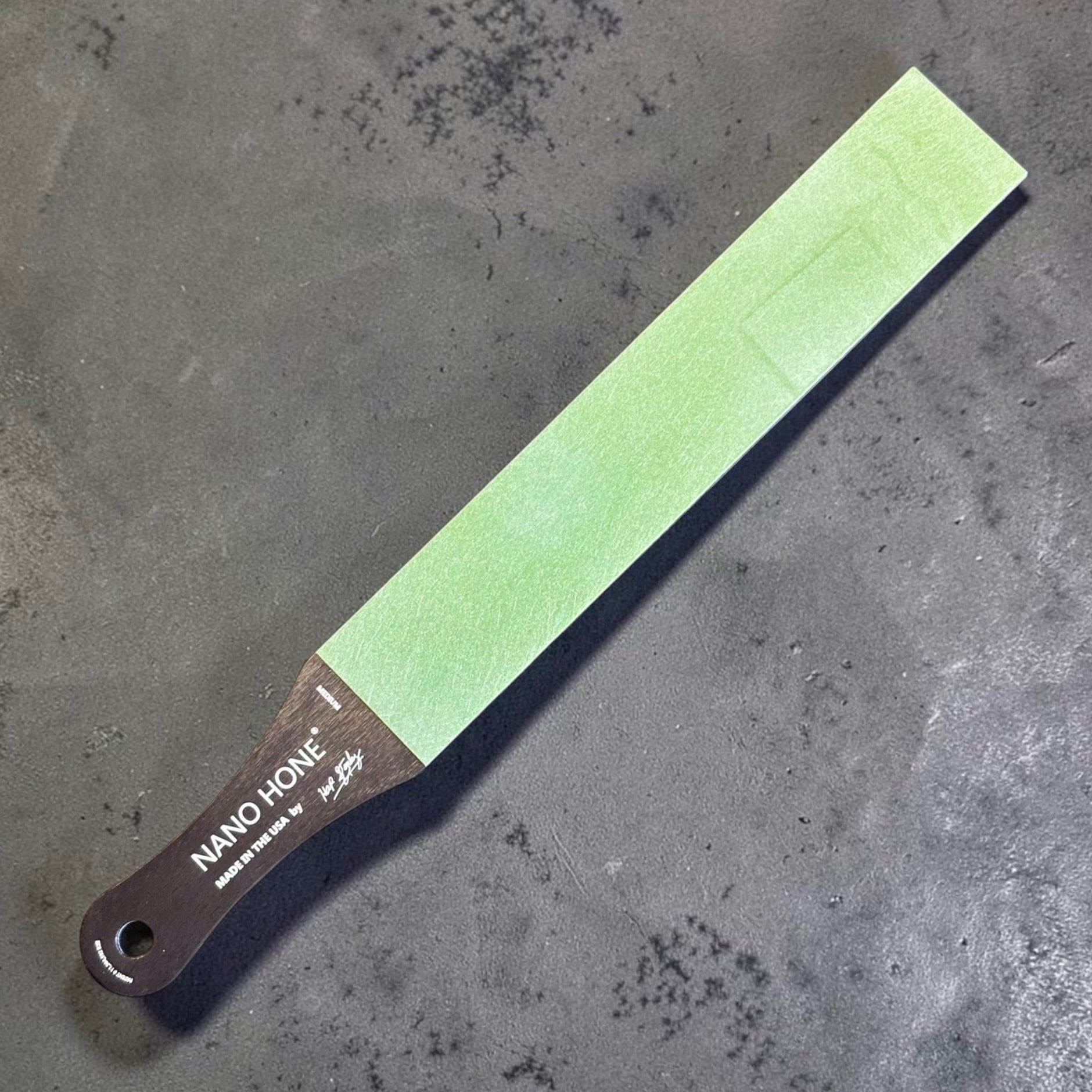 Nano Hone Truer 3/50 paddle strop showing the green 50 micron medium diamond resin side