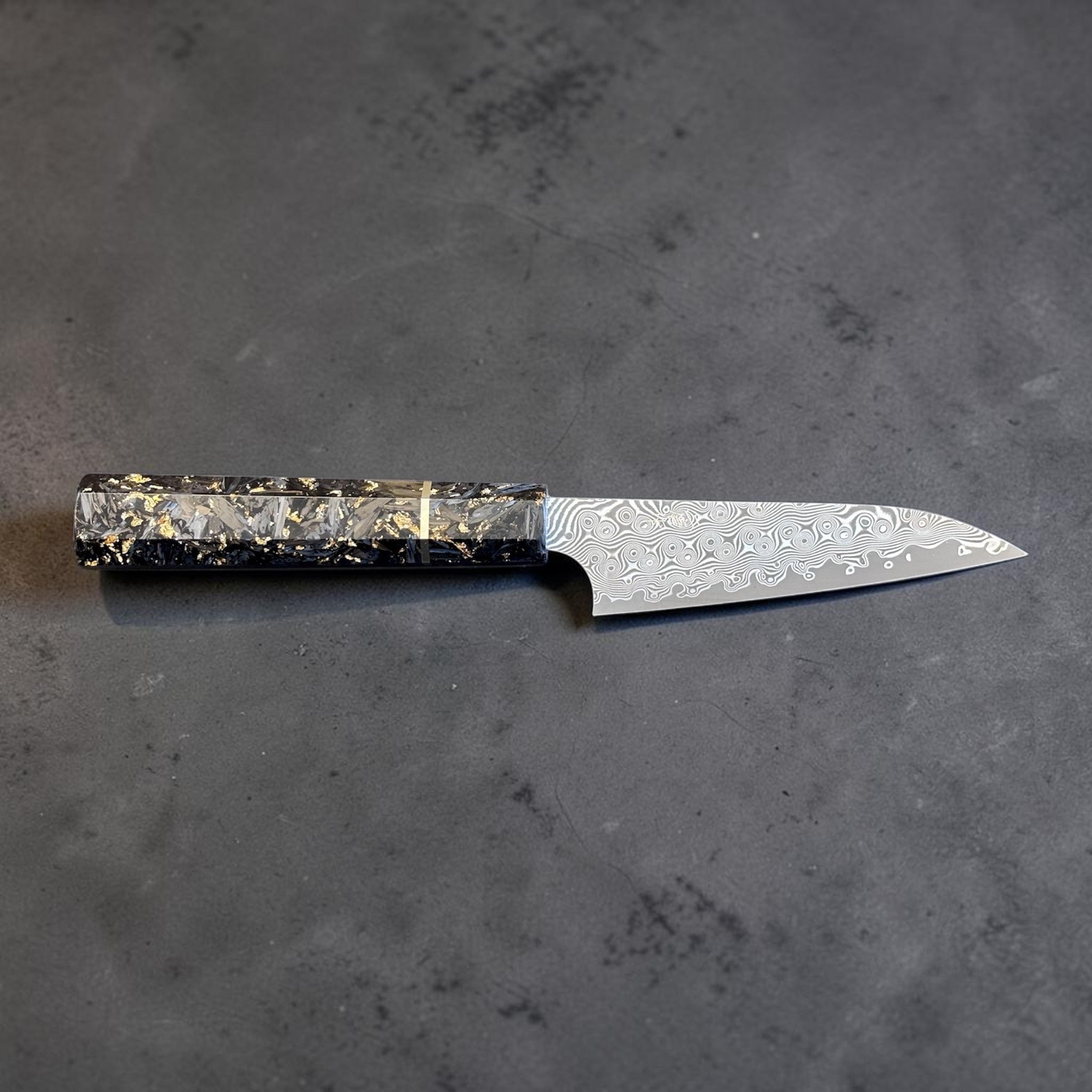 Nigara Anmon SG2 Petty 120 mm with carbon fiber and gold fleck handle, horizontal full-profile product photo.