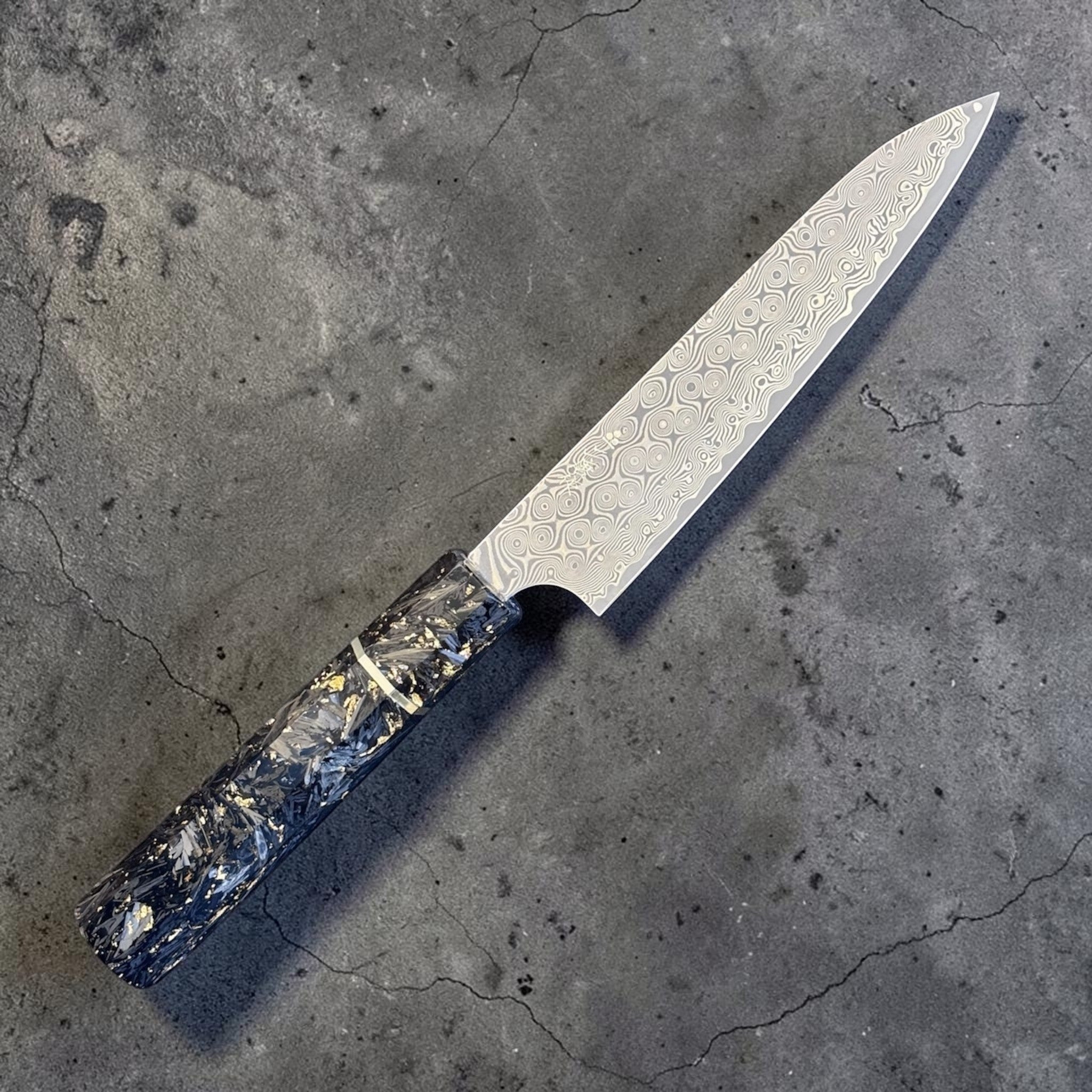 Nigara Anmon SG2 Petty 150 mm with carbon fiber and gold fleck handle, alternate angled view highlighting the damascus blade pattern.