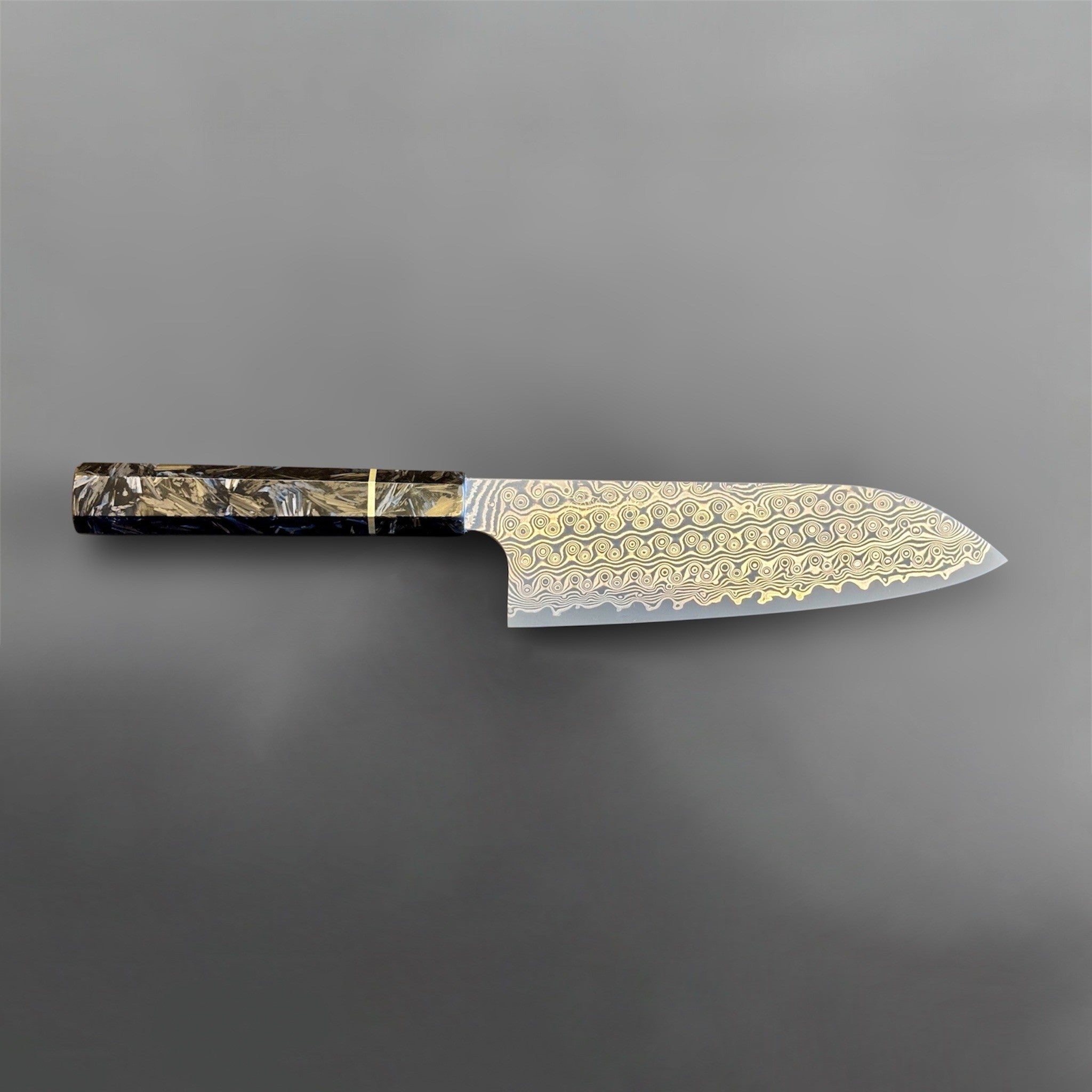 Nigara Anmon SG2 Santoku with carbon fiber wa handle, full side profile on gray background showing the complete blade and handle.