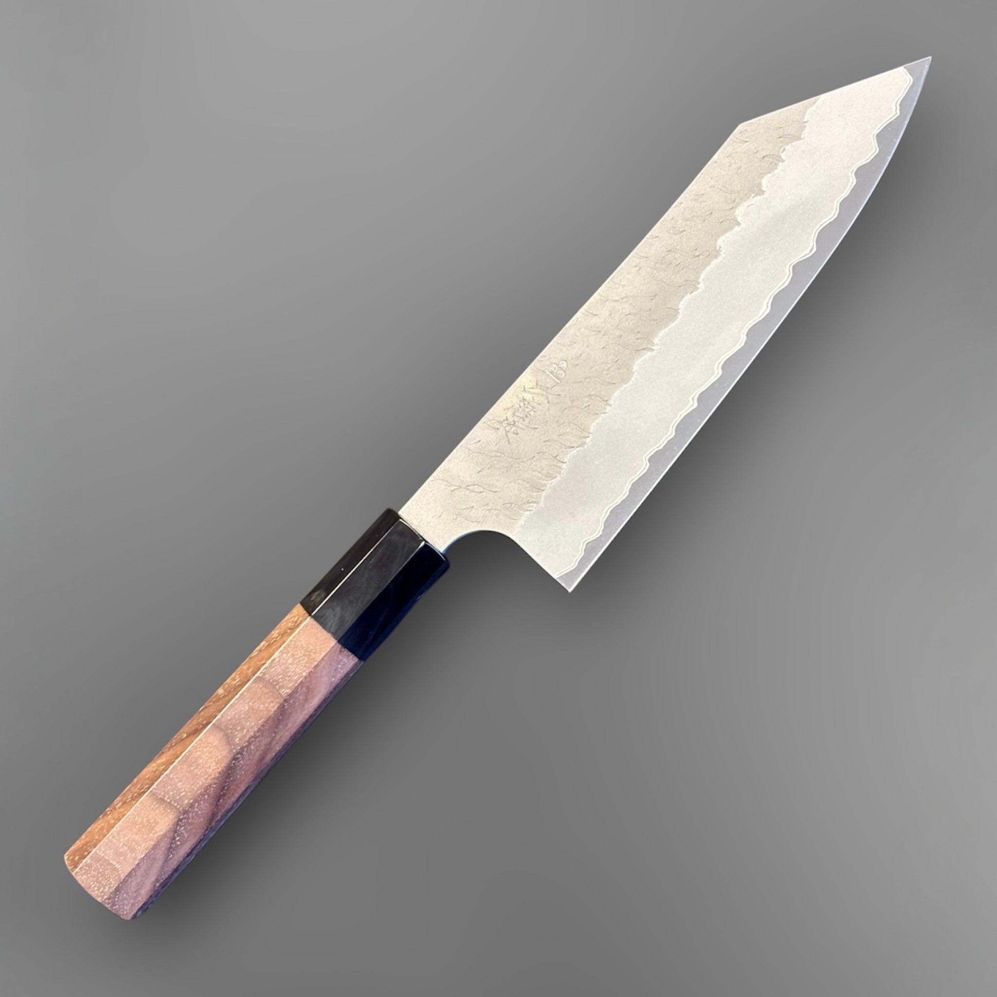 Nigara Aogami Super Steel Tsuchime Bunka 180 mm with walnut and horn handle, angled front view of the full knife.