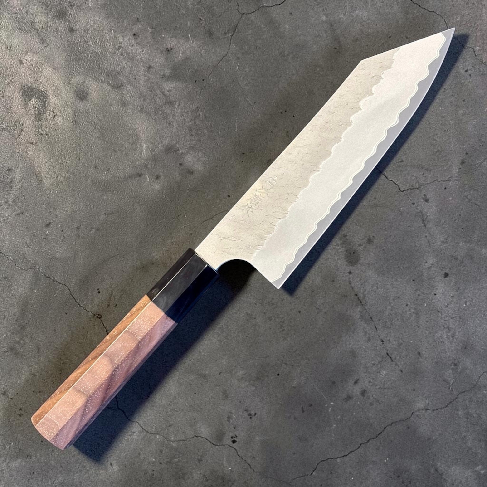 Nigara Aogami Super Steel Tsuchime Bunka 180 mm with walnut and horn handle, angled front view of the full knife.