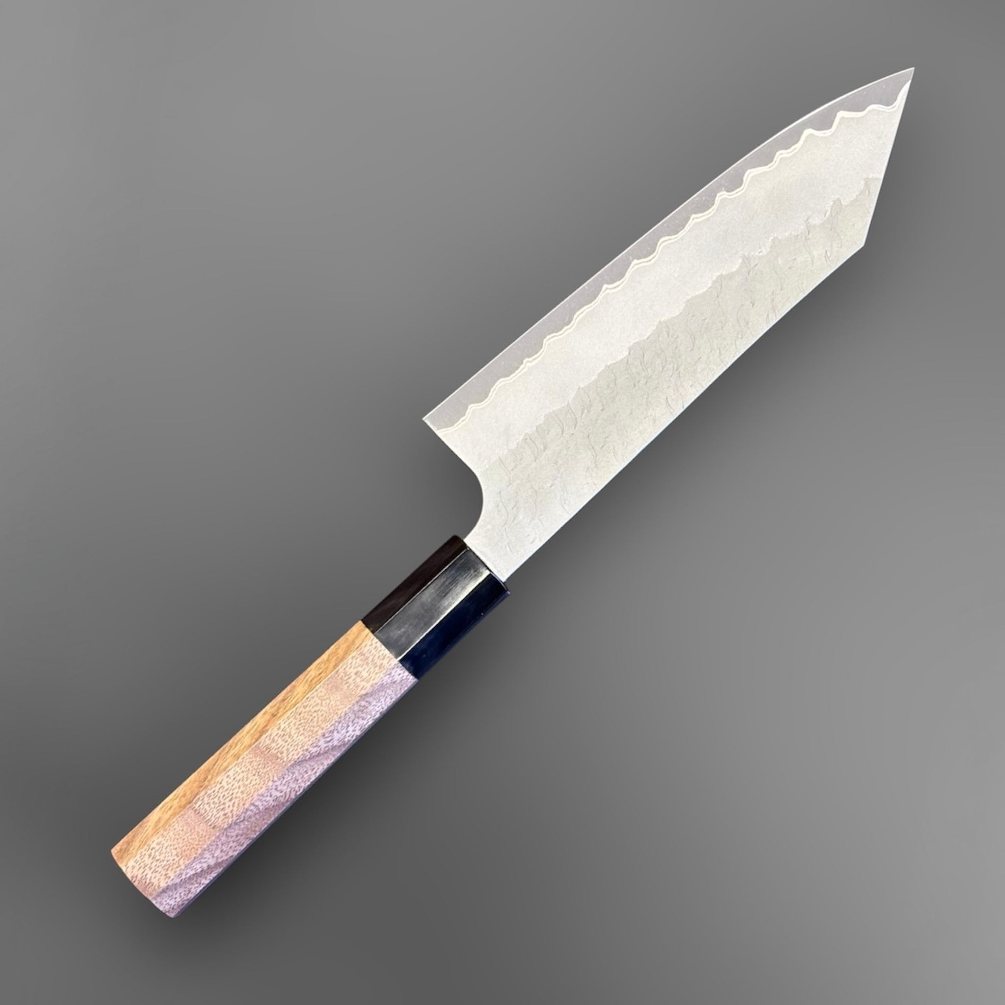 Nigara Aogami Super Steel Tsuchime Bunka 180 mm with walnut and horn handle, angled reverse-side view of the blade and handle.