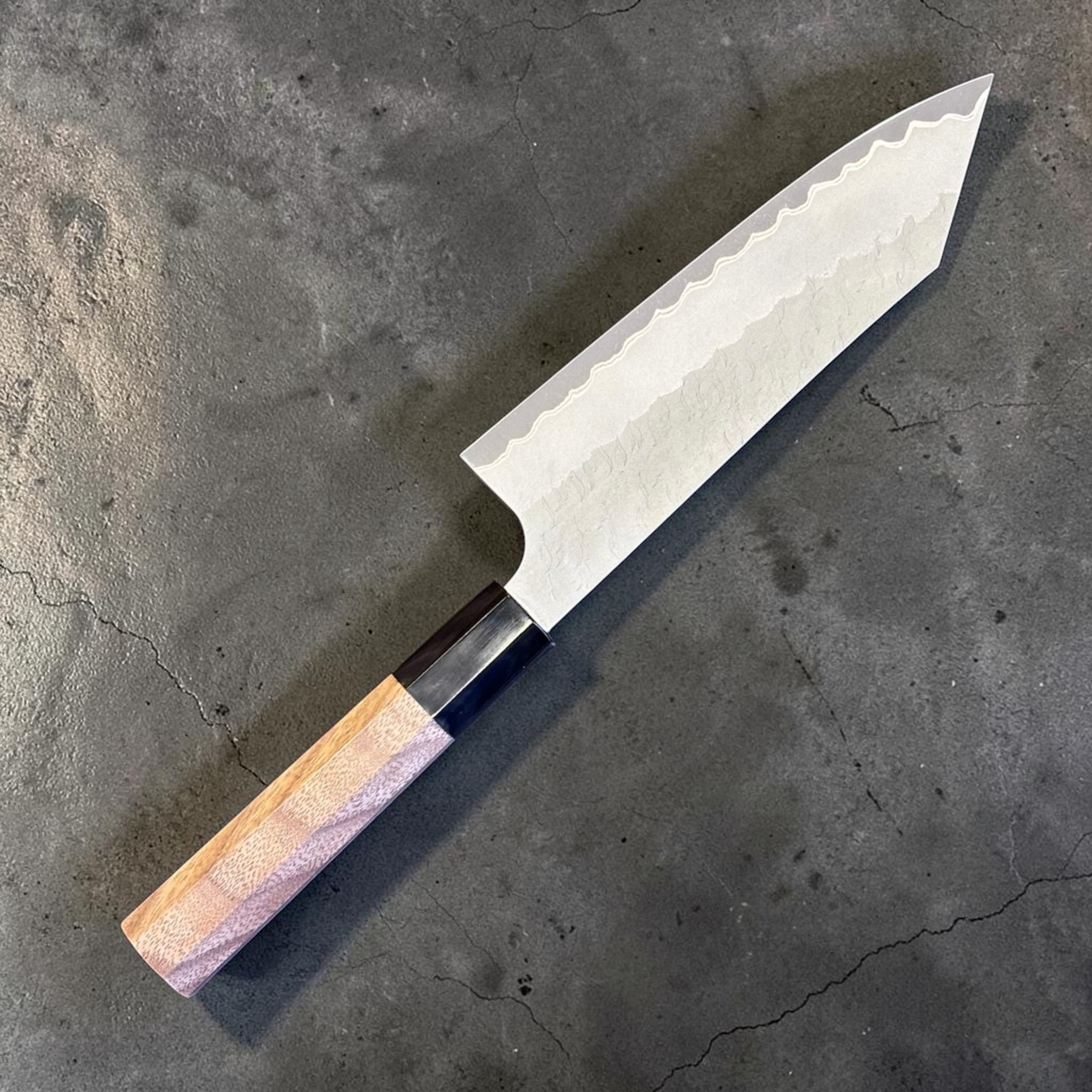 Nigara Aogami Super Steel Tsuchime Bunka 180 mm with walnut and horn handle, angled reverse-side view of the blade and handle.