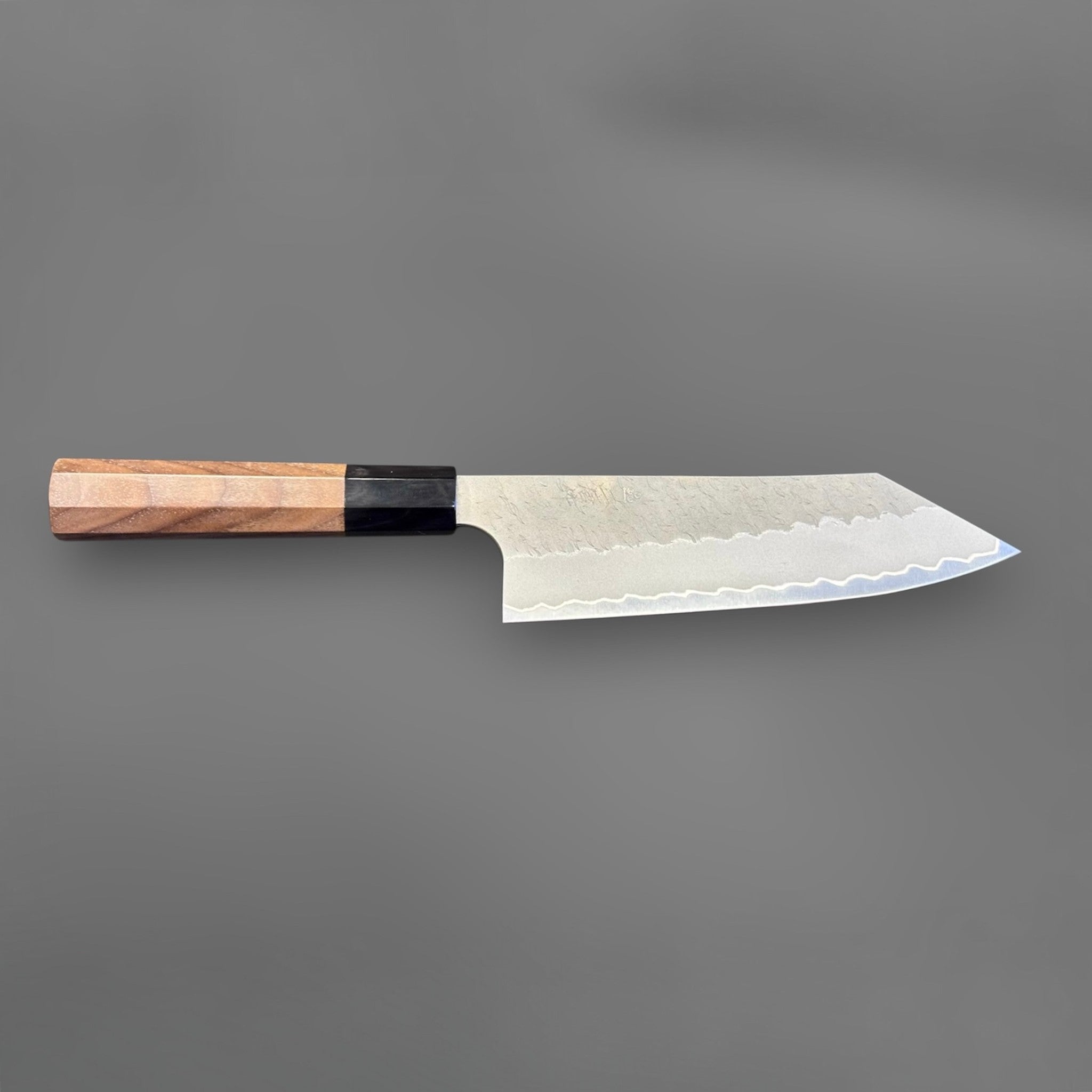 Nigara Aogami Super Steel Tsuchime Bunka 180 mm with walnut and horn handle, full profile view with blade facing right.