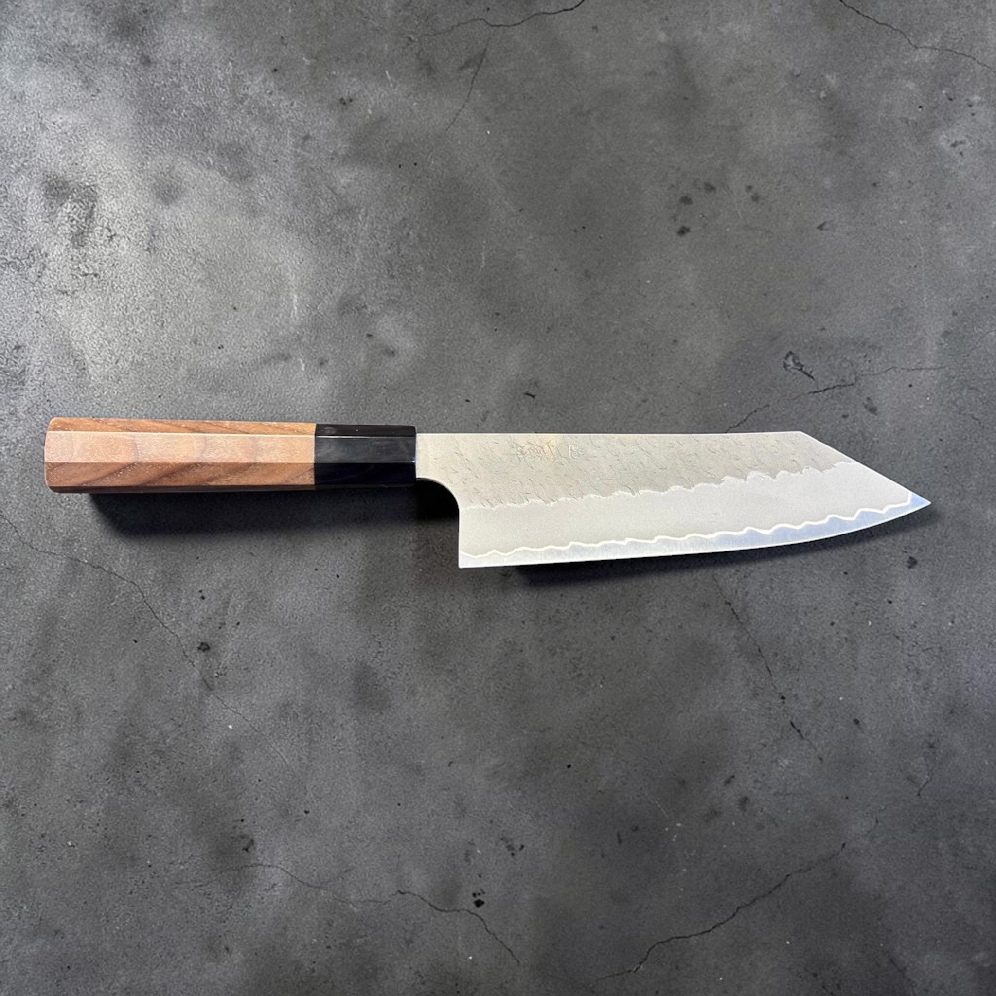 Nigara Aogami Super Steel Tsuchime Bunka 180 mm with walnut and horn handle, full profile view with blade facing right.