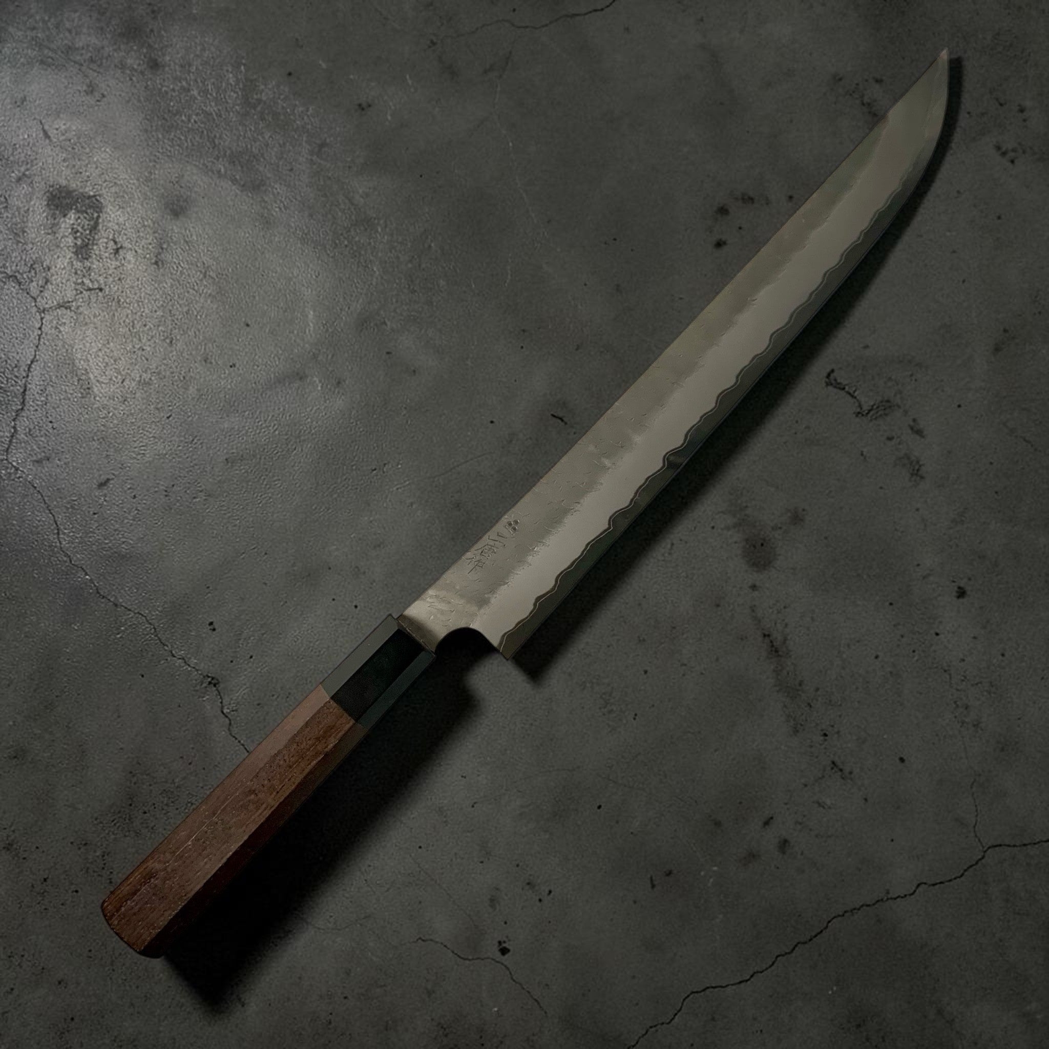 Nigara AS Tsuchime Sakimaru Sujihiki 300 mm — right-side profile showing hammered cladding line and glossy finish.