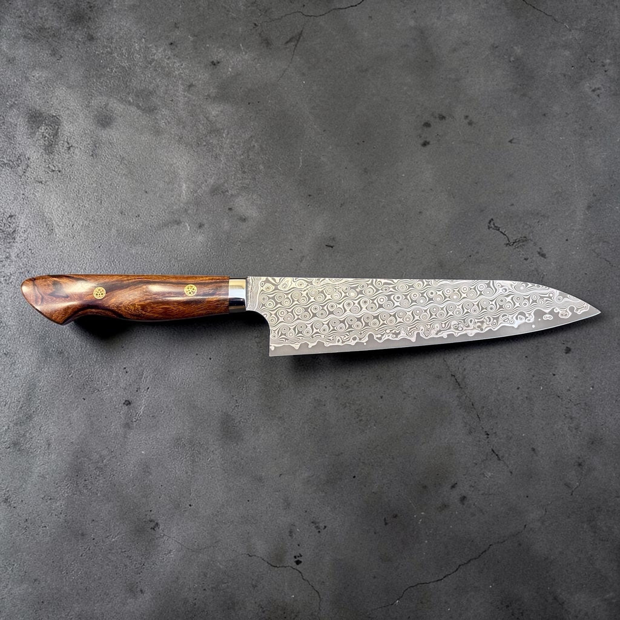Nigara Hamono Anmon SG2 210 mm Gyuto with ironwood western handle, full side profile showing Anmon Damascus pattern.