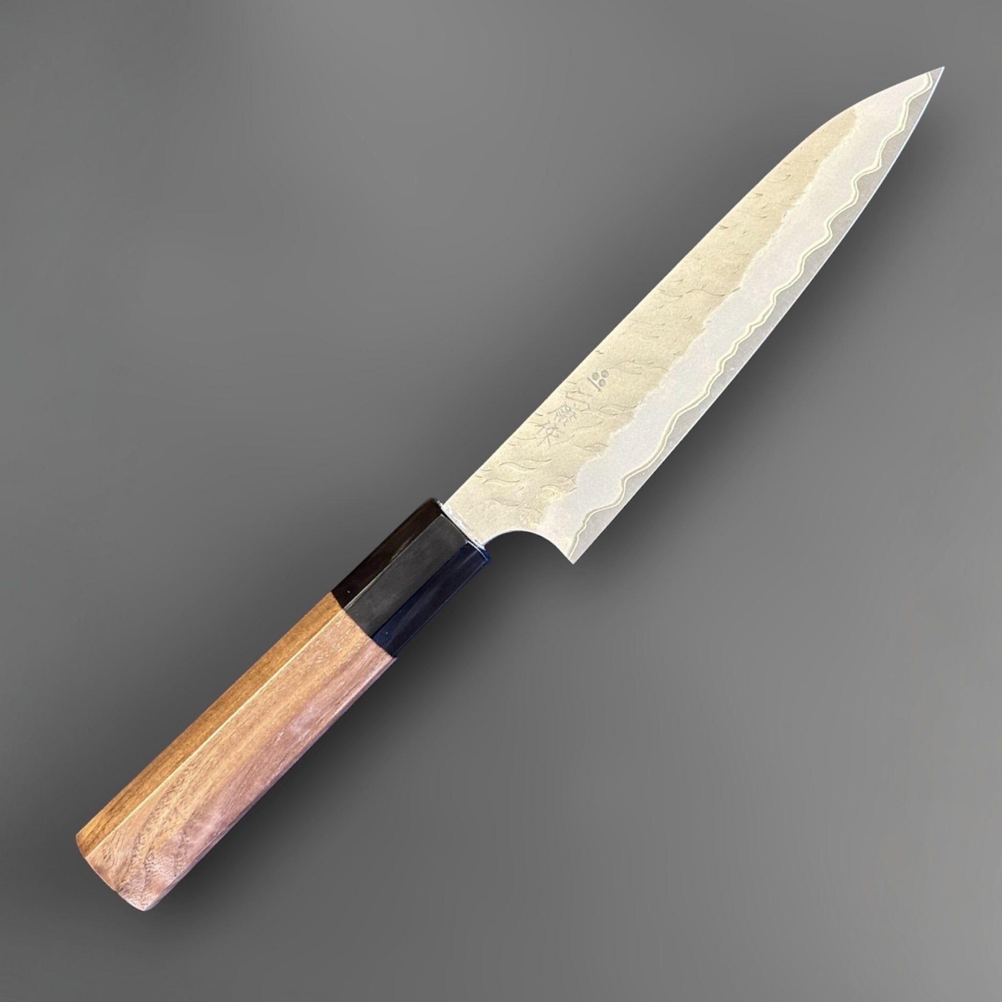 Nigara Hamono Aogami Super Tsuchime Petty 150 mm with walnut horn handle, angled full knife view.