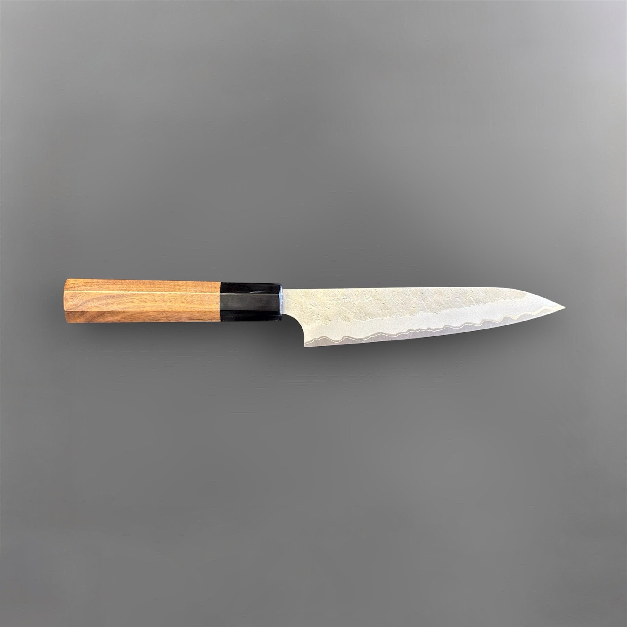 Nigara Hamono Aogami Super Tsuchime Petty 150 mm with walnut horn handle, side profile full knife view.