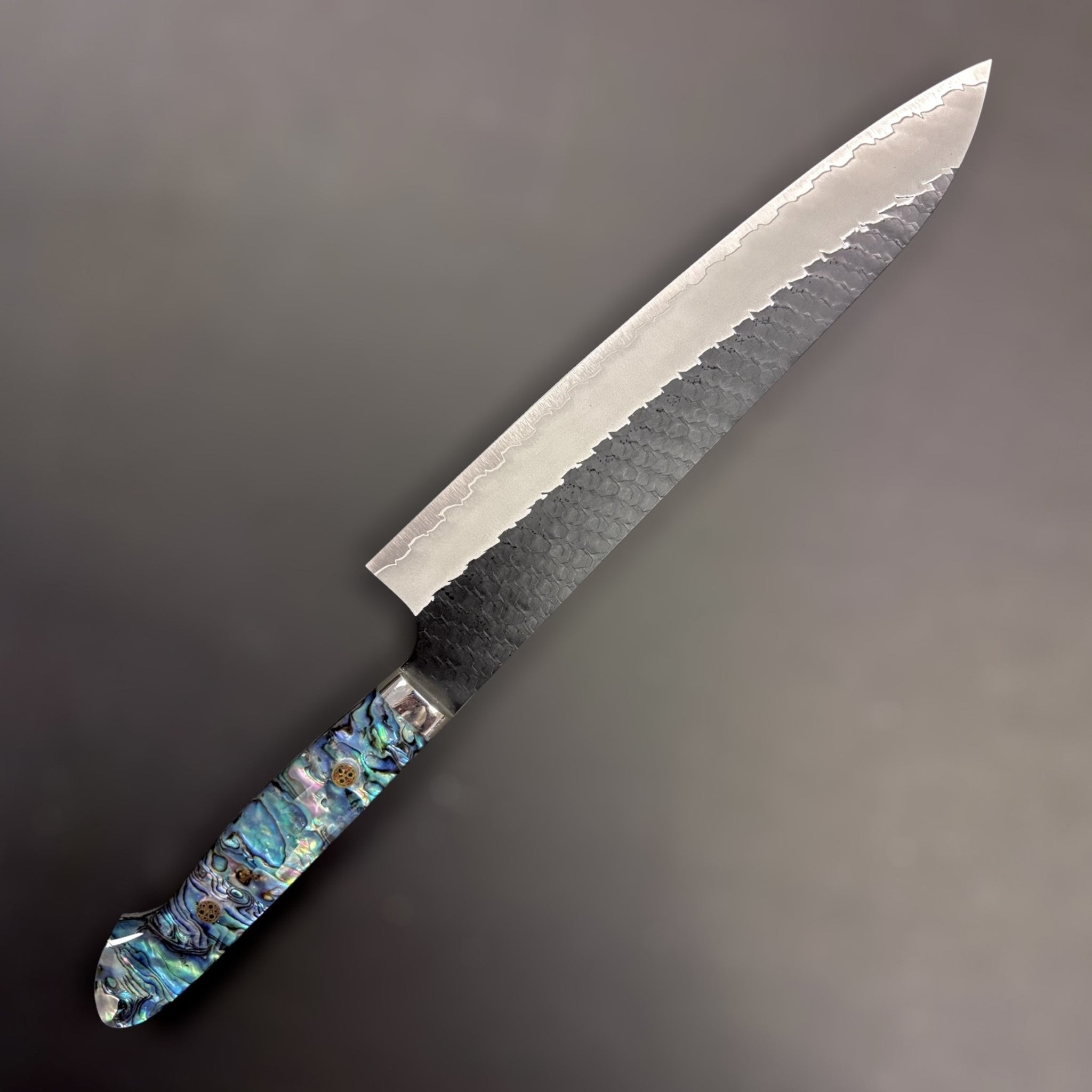 Nigara Hamono SG2 Kurouchi Tsuchime Gyuto 240 mm with abalone Western handle, left-side view.
