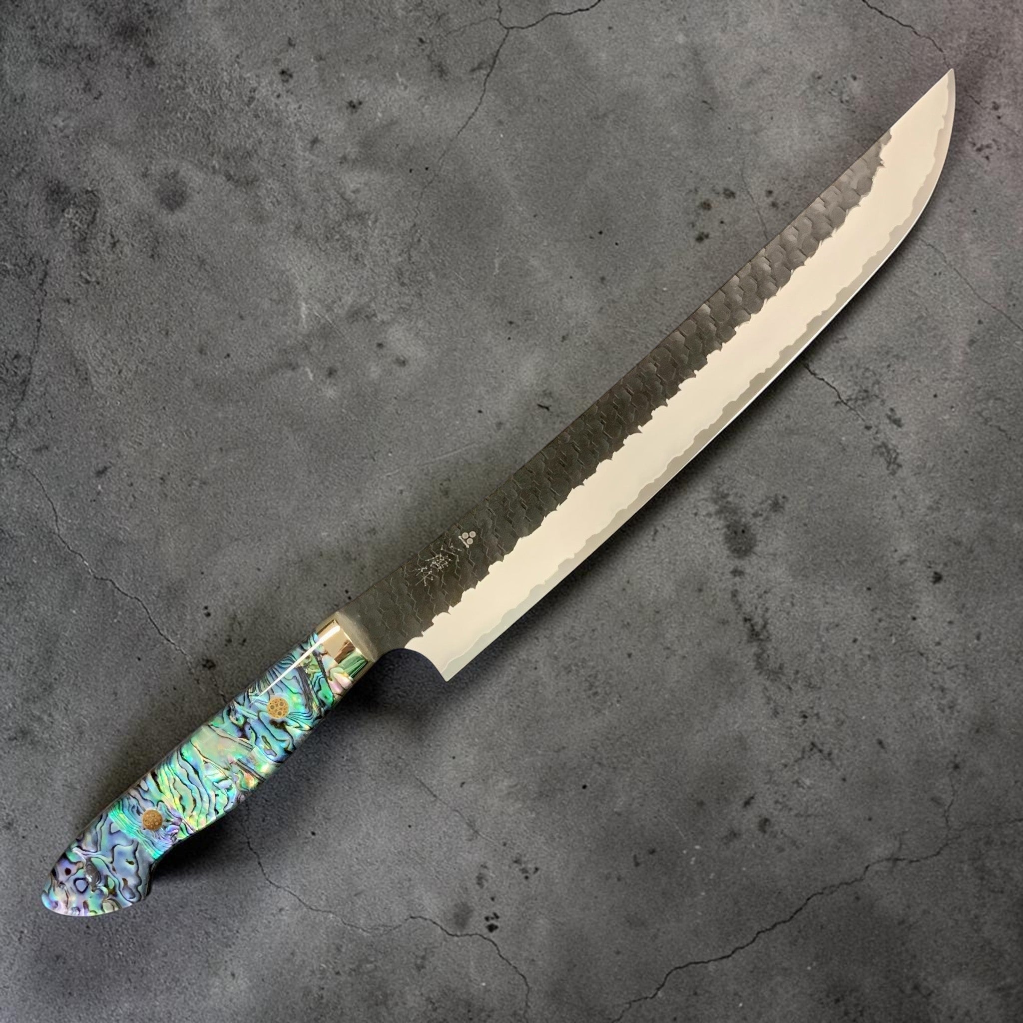 Nigara Hamono SG2 Kurouchi Tsuchime Sujihiki 270 mm, right side profile with abalone Western handle.