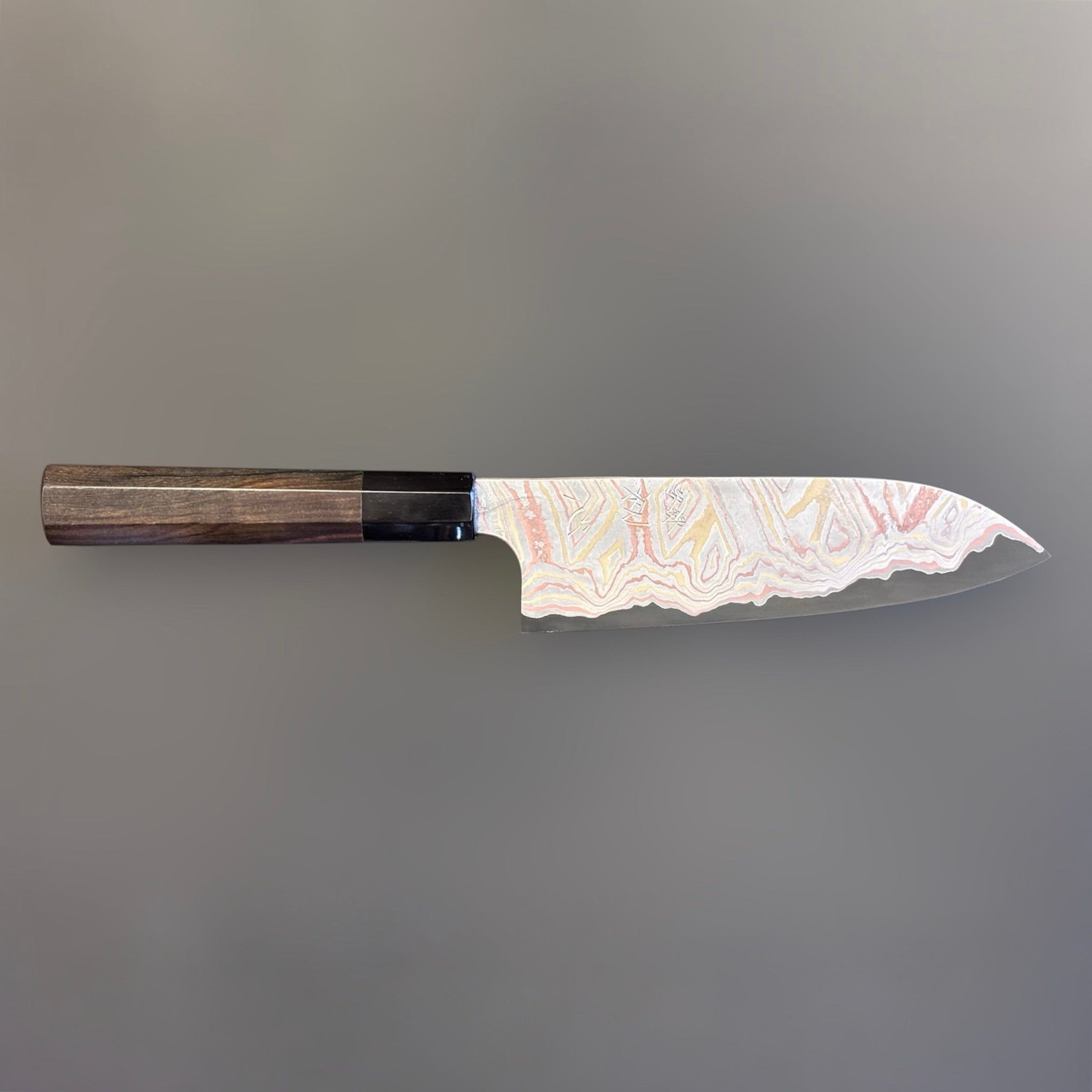 Nigara Irodori Blue #2 Rainbow Damascus Santoku 180 mm with ebony and horn handle, full profile view showing the flowing multicolor damascus pattern across the blade.