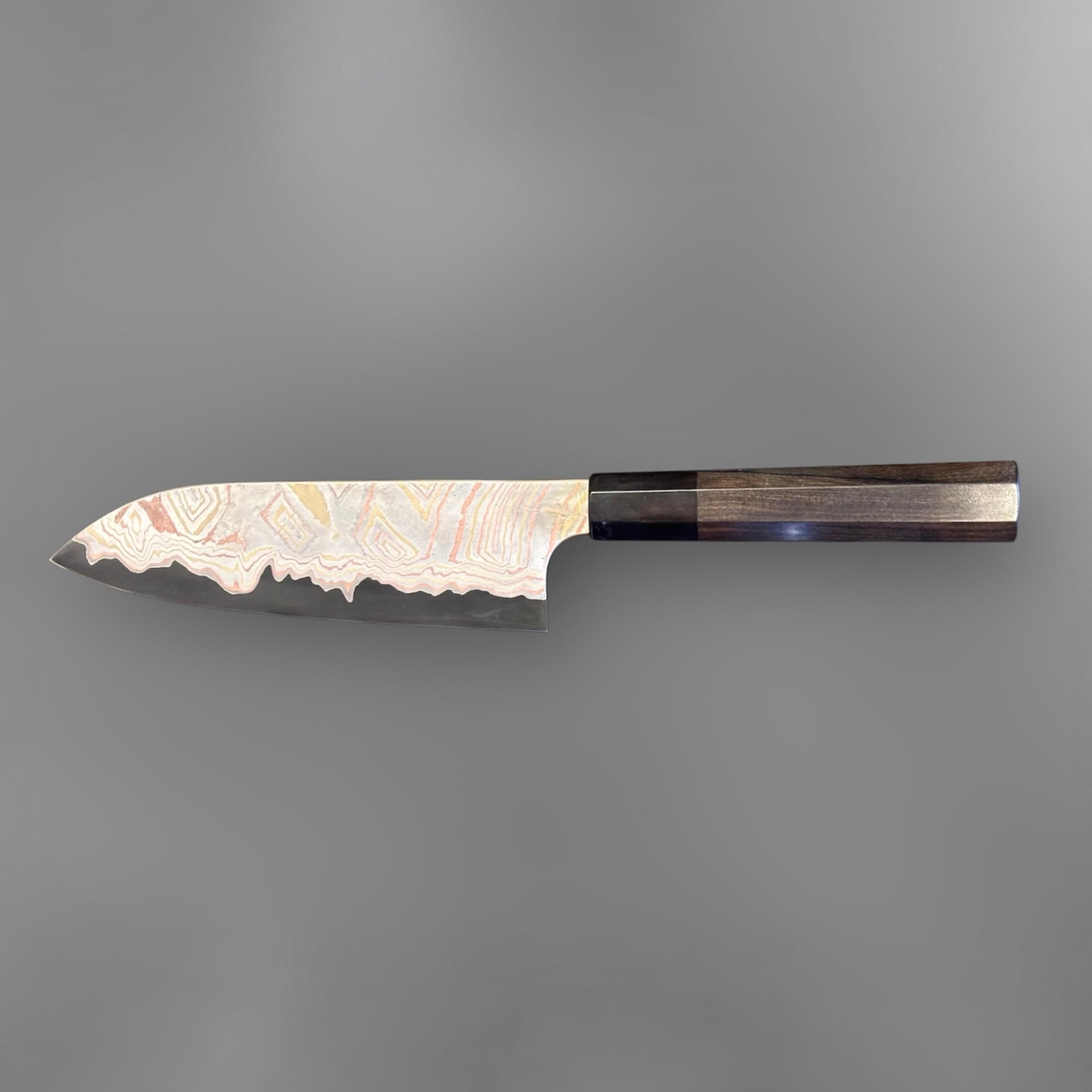 Nigara Irodori Blue #2 Rainbow Damascus Santoku 180 mm with ebony and horn handle, reverse profile view showing the flowing multicolor damascus pattern across the blade.