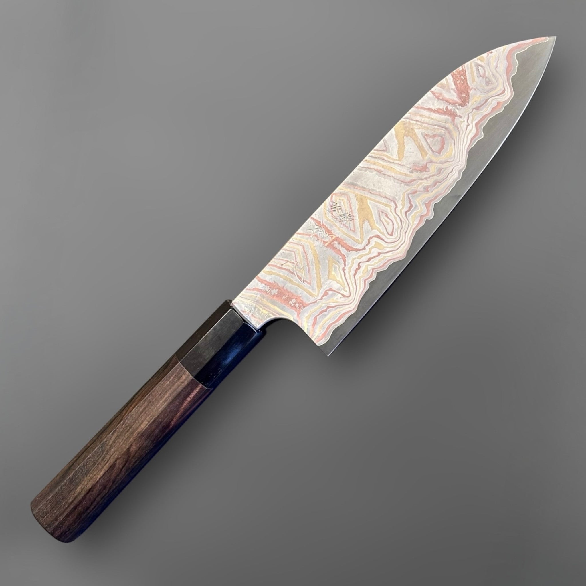 Nigara Irodori Blue #2 Rainbow Damascus Santoku 180 mm with ebony and horn handle, full profile view showing the flowing multicolor damascus pattern across the blade.