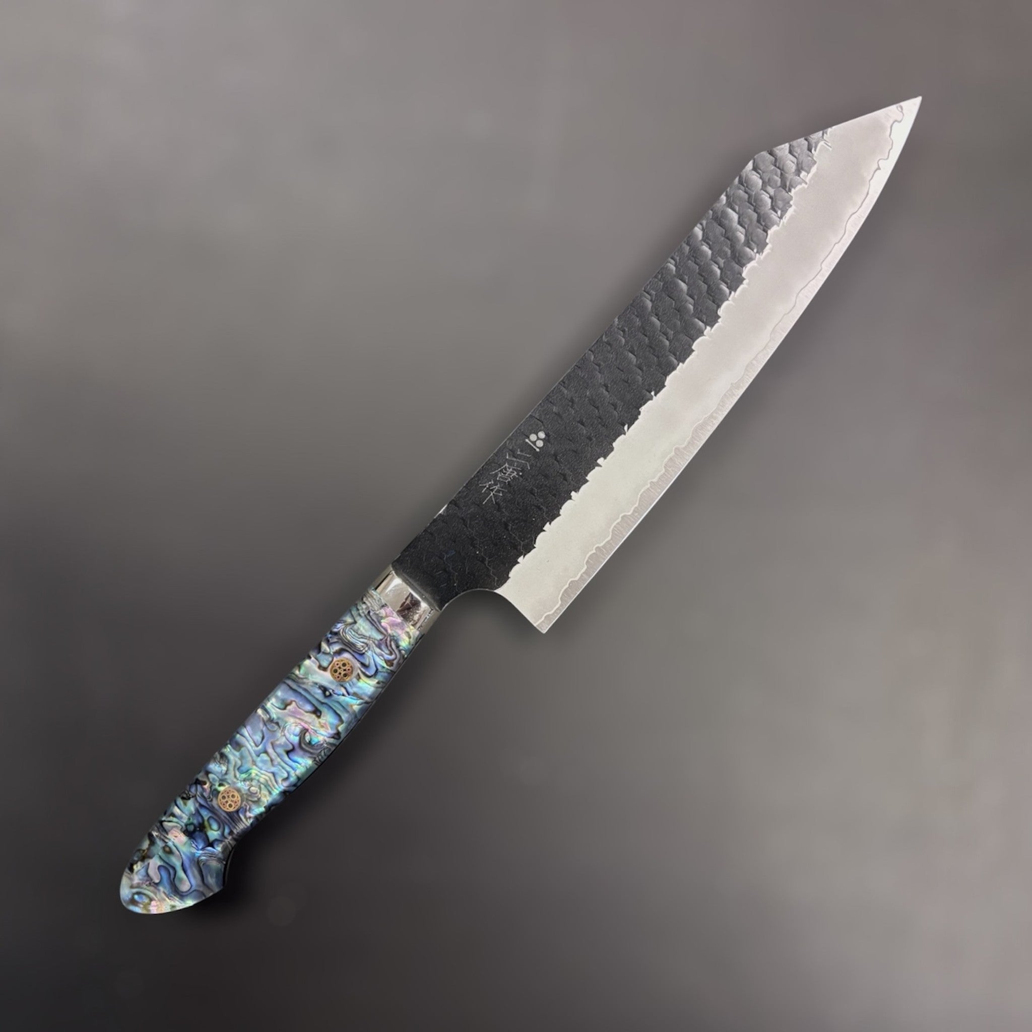 Nigara SG2 Kurouchi Tsuchime Kiritsuke 210 mm, right side profile with hammered finish and abalone Western handle.