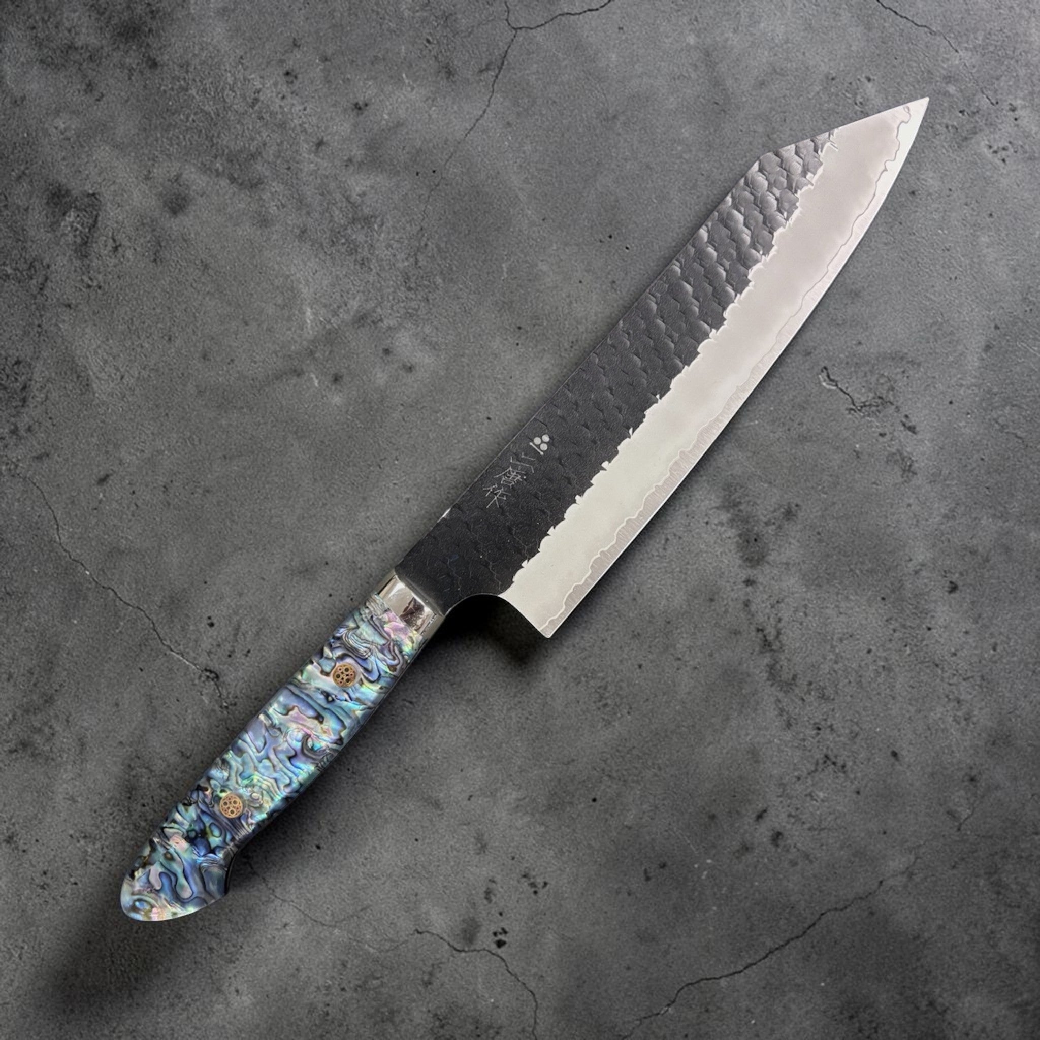 Nigara SG2 Kurouchi Tsuchime Kiritsuke 210 mm, right side profile with hammered finish and abalone Western handle.