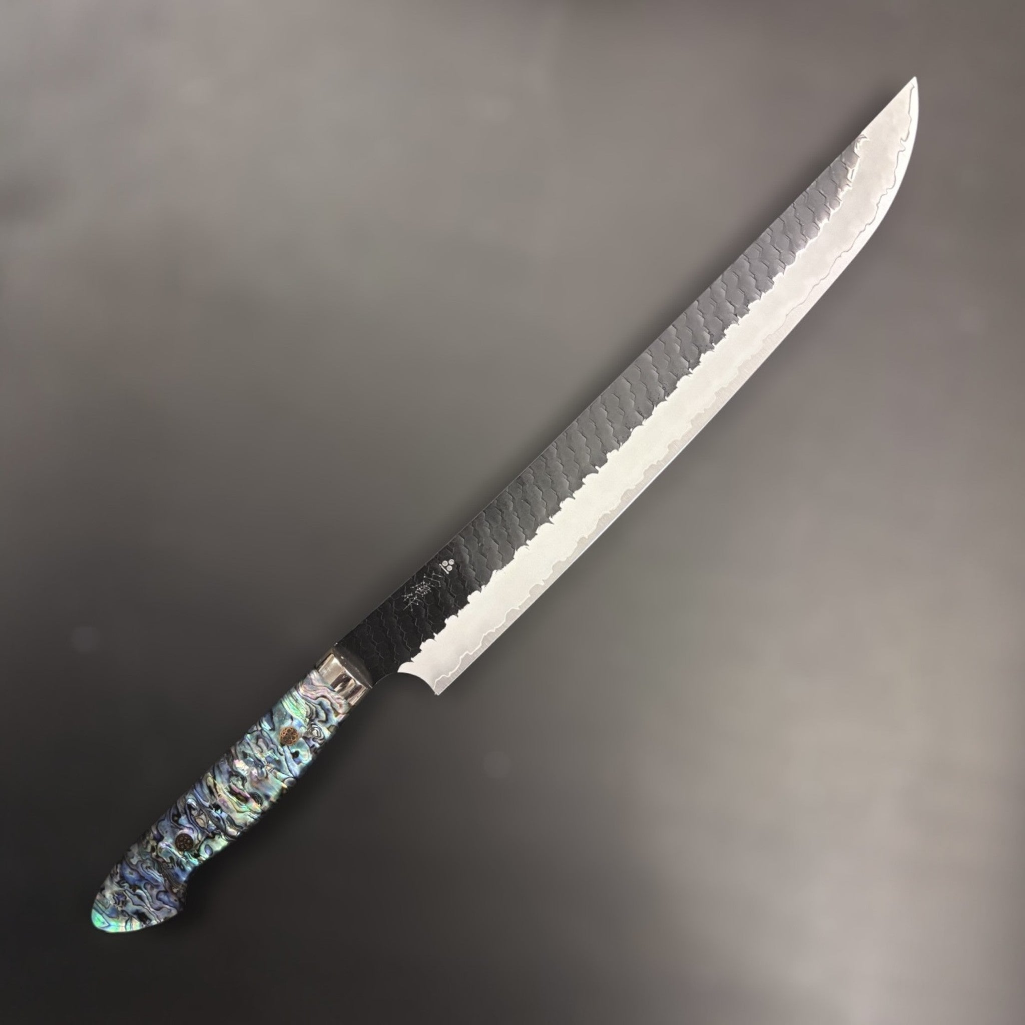 Nigara Hamono SG2 Kurouchi Tsuchime Sujihiki 300 mm with abalone western handle, right side profile.