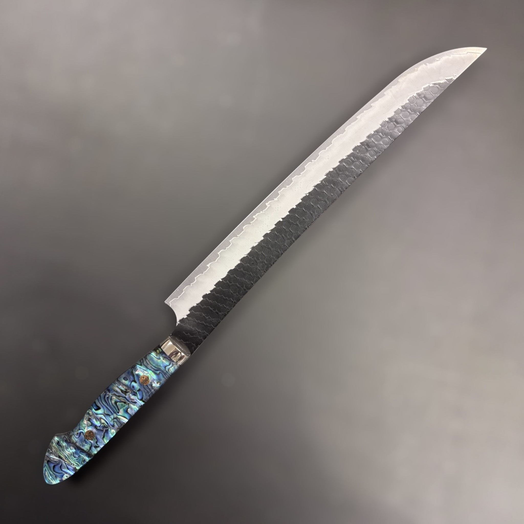 Nigara Hamono SG2 Kurouchi Tsuchime Sujihiki 300 mm with abalone western handle, left side profile.