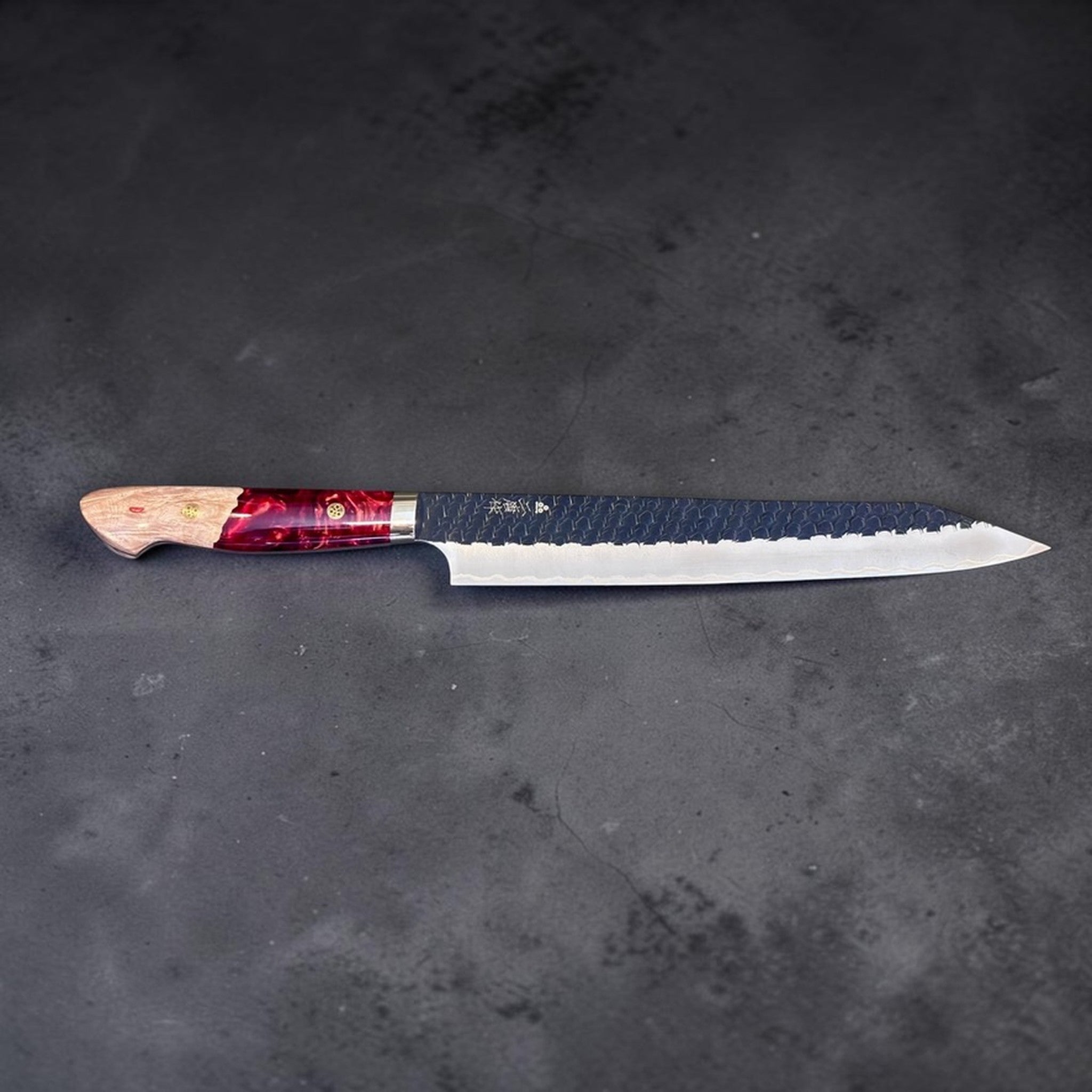 Nigara SG2 Kurouchi Tsuchime Sujihiki 255 mm with hybrid western handle, reverse-side profile showing kurouchi tsuchime blade finish.