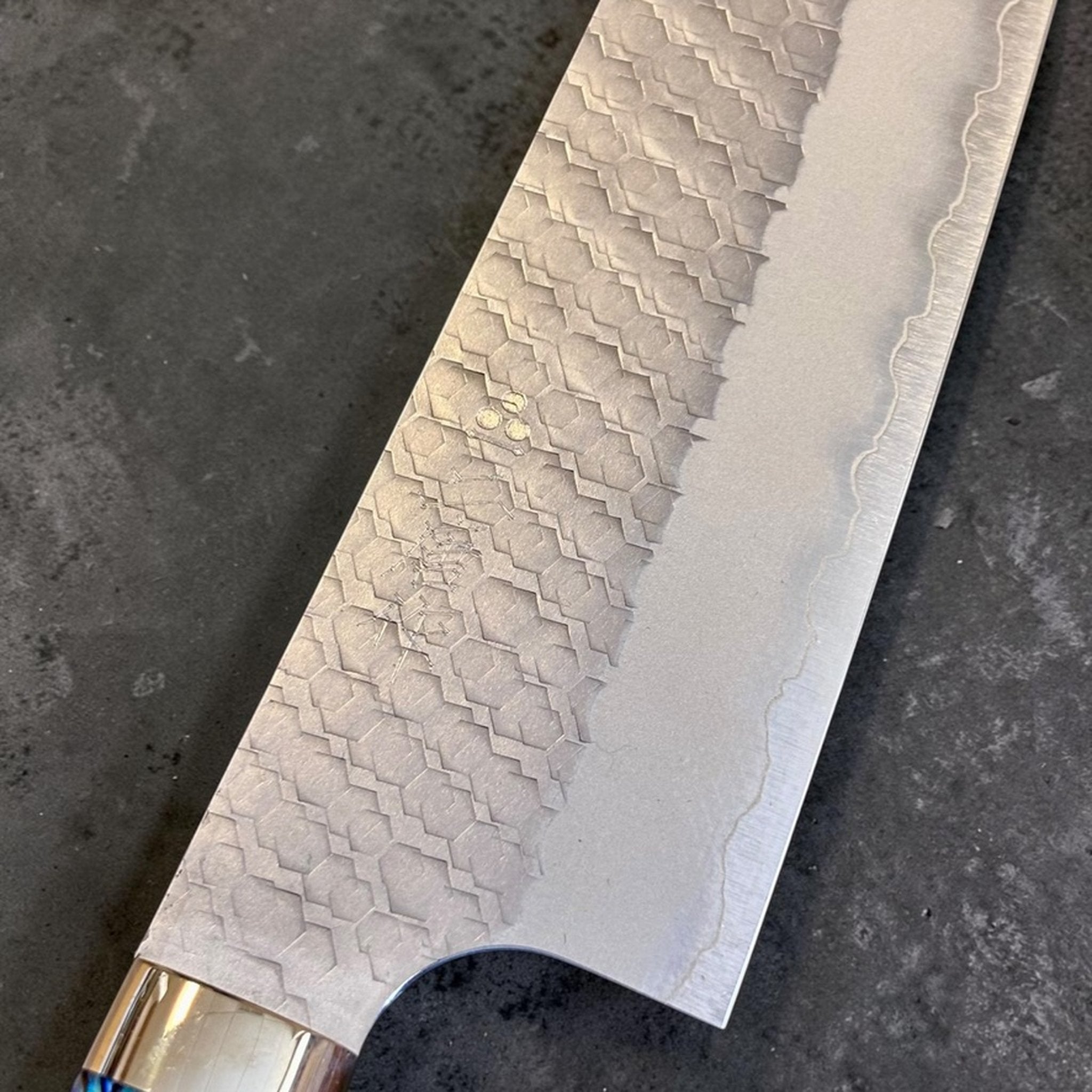 Nigara SG2 Tsuchime Gyuto 240 mm, close-up of SG2 tsuchime blade texture and polished edge line.