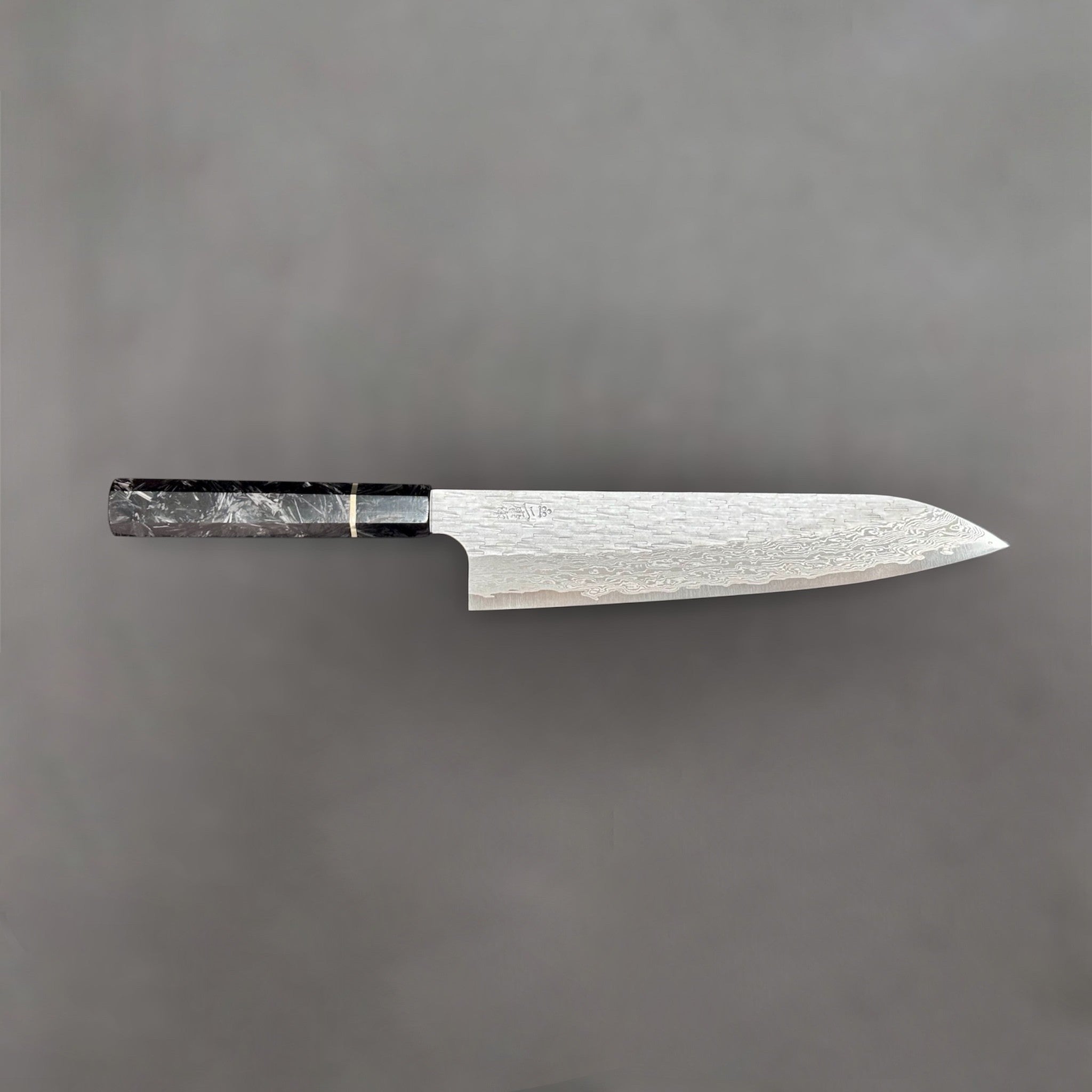 Nigara VG-XEOS Tsuchime Gyuto 210 mm with carbon fiber handle, close-up view highlighting hammered tsuchime finish and blade geometry. Profile shot.