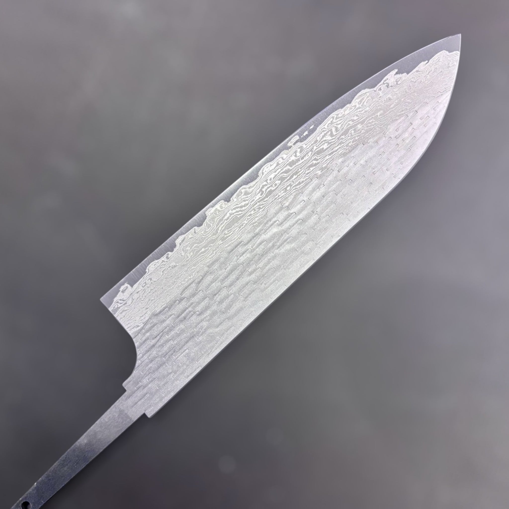 Nigara VG-XOES Damascus Santoku 165 mm blade-only version, close-up of layered Damascus steel pattern left side.