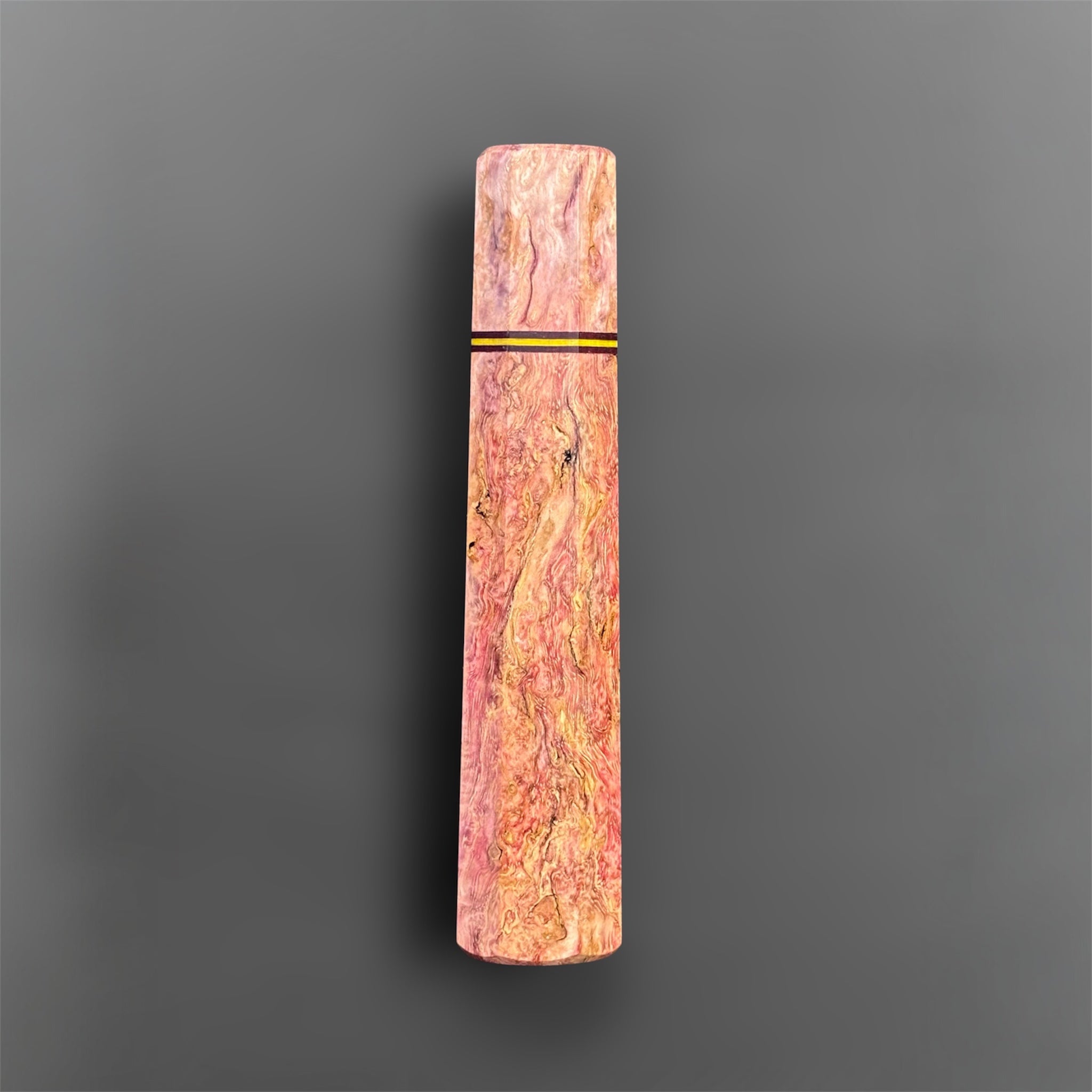 Prisma Knife Handle 1, pink and gold figured wood wa handle with black and yellow accent spacer.