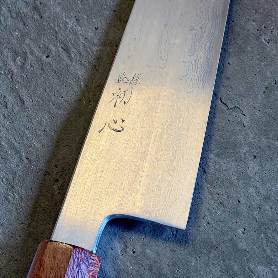 Satoshi Nakagawa and Morihiro Blue #1 Damascus 240mm gyuto, close-up of blade engraving and layered Damascus.