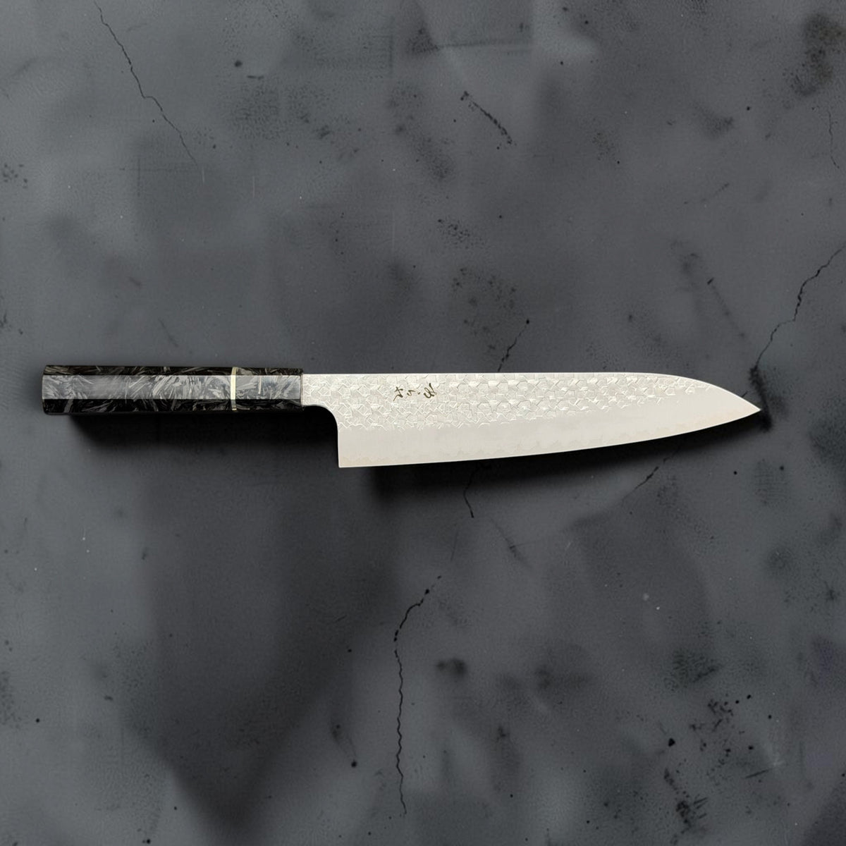 Full side profile of the Shibata Arare SG2 gyuto 210mm with its carbon fiber handle on the left.