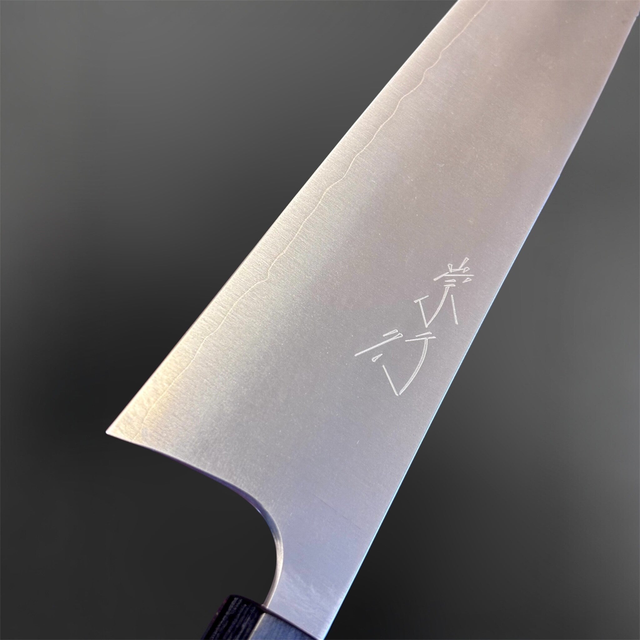 Shibata Koutetsu Chromax Gyuto 210 mm, close-up of blade face with kanji and visible cladding line.