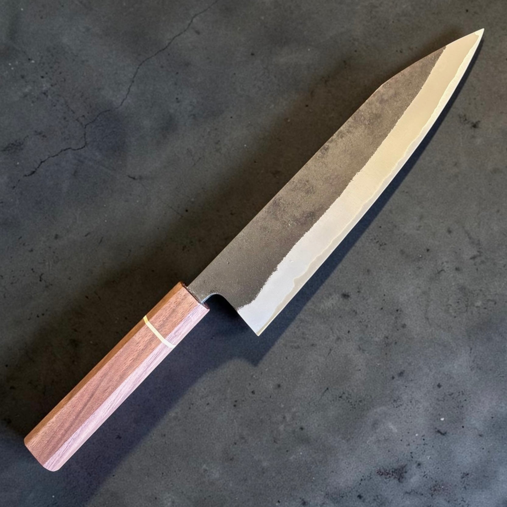 Shotaro Imai Gyuto 218mm blade detail showing Aogami Super edge, stainless cladding line and traditional Kurouchi finish