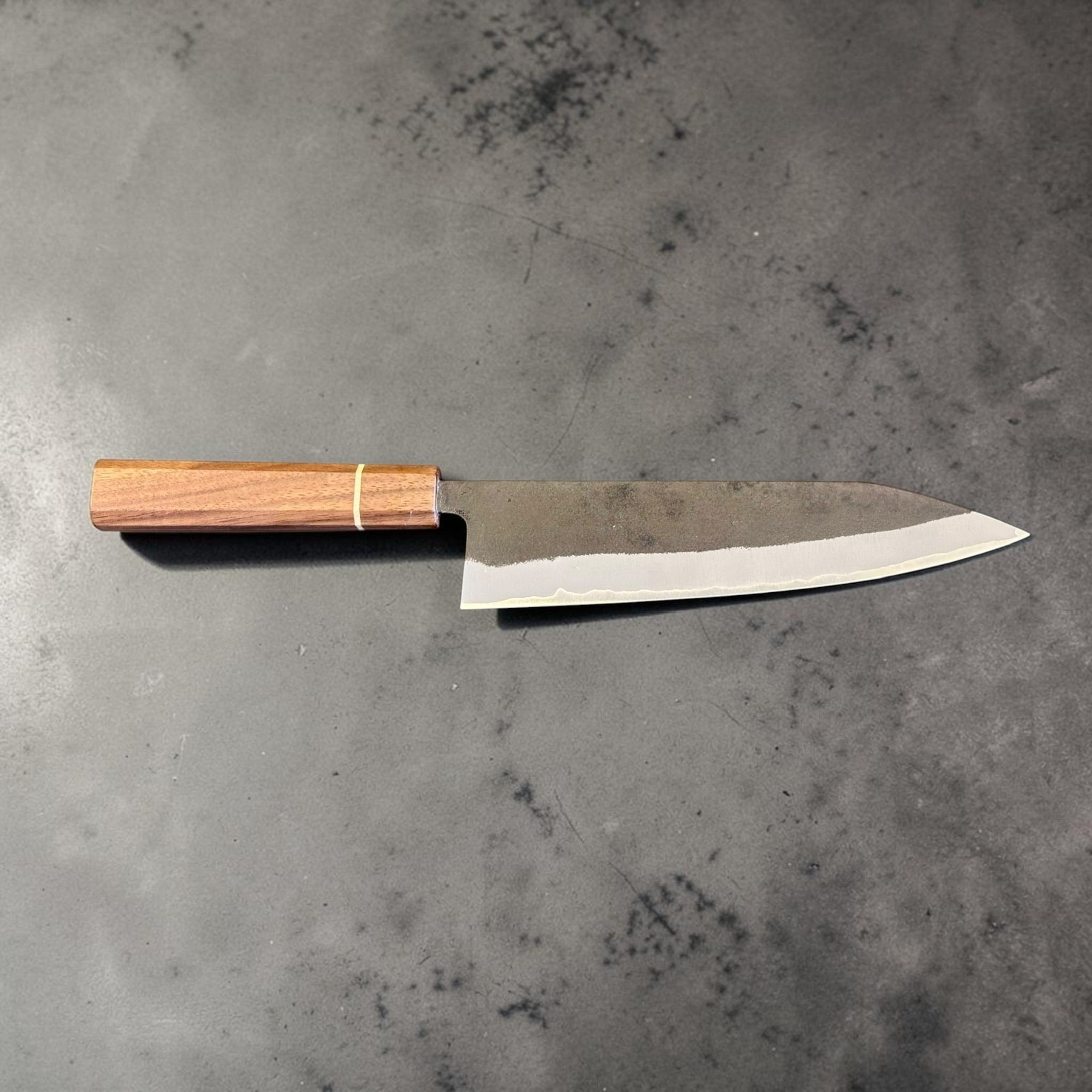 Shotaro Imai Aogami Super Gyuto 218mm left-side blade profile showing Kurouchi finish, stainless cladding and walnut wa handle