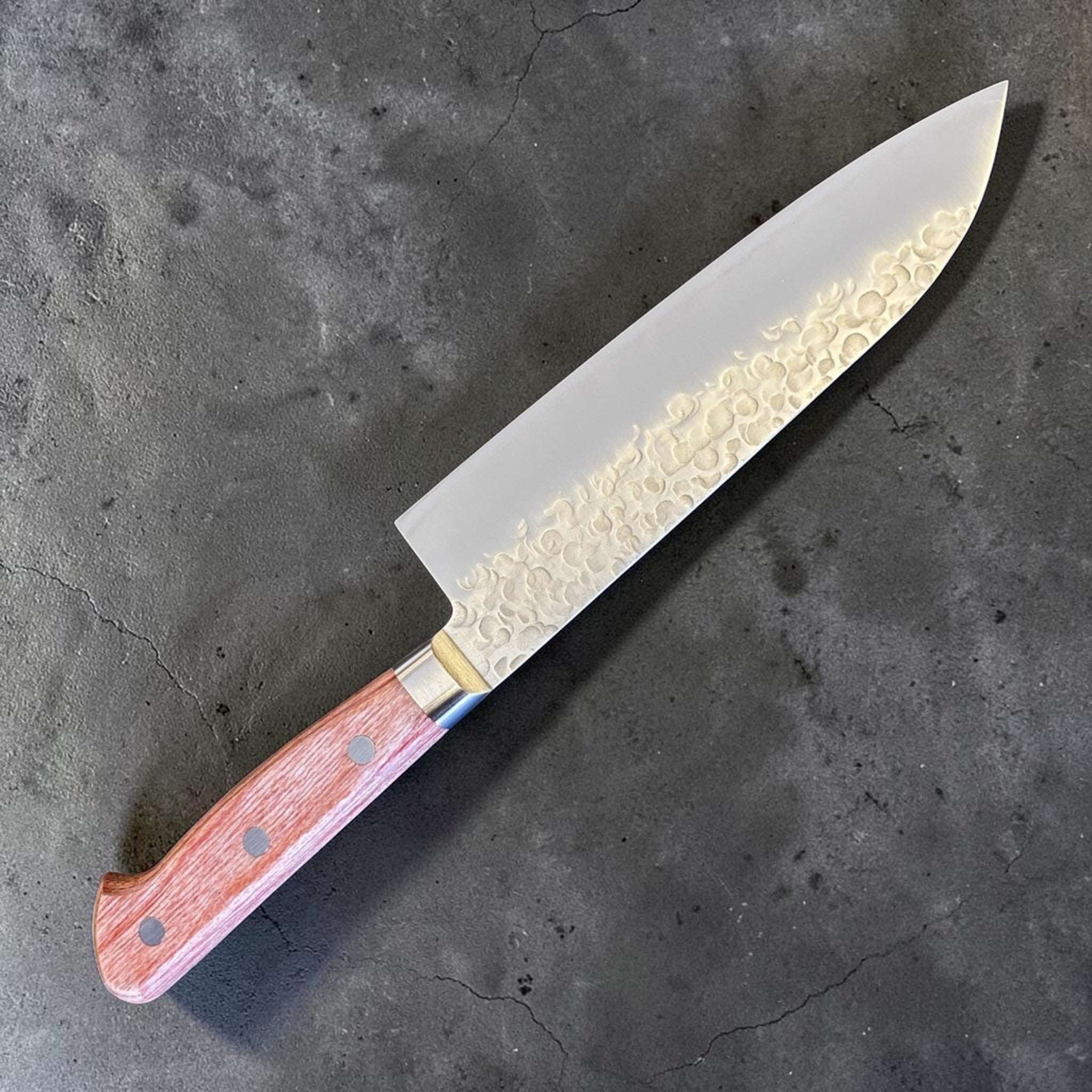 Takamura Chromax Santoku 170 mm, angled full-knife view with hammered blade finish and western handle.