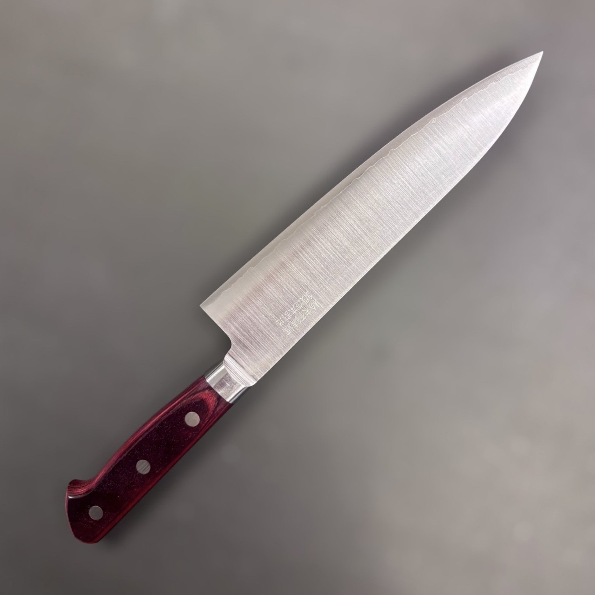 Takamura SG2 Gyuto 180 mm, left-side face with kanji engraving and brushed migaki finish; red Western handle.