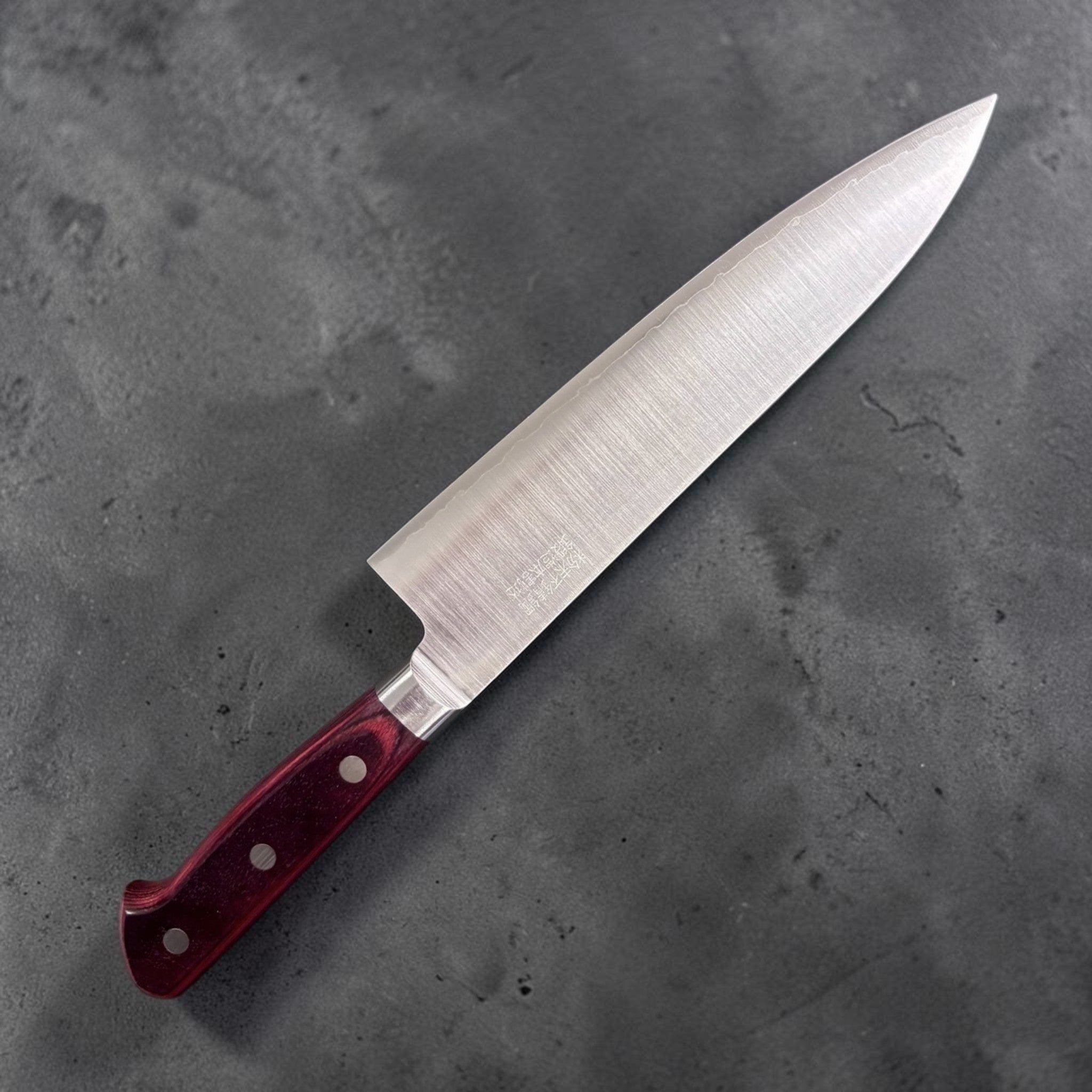 Takamura SG2 Gyuto 180 mm, left-side face with kanji engraving and brushed migaki finish; red Western handle.