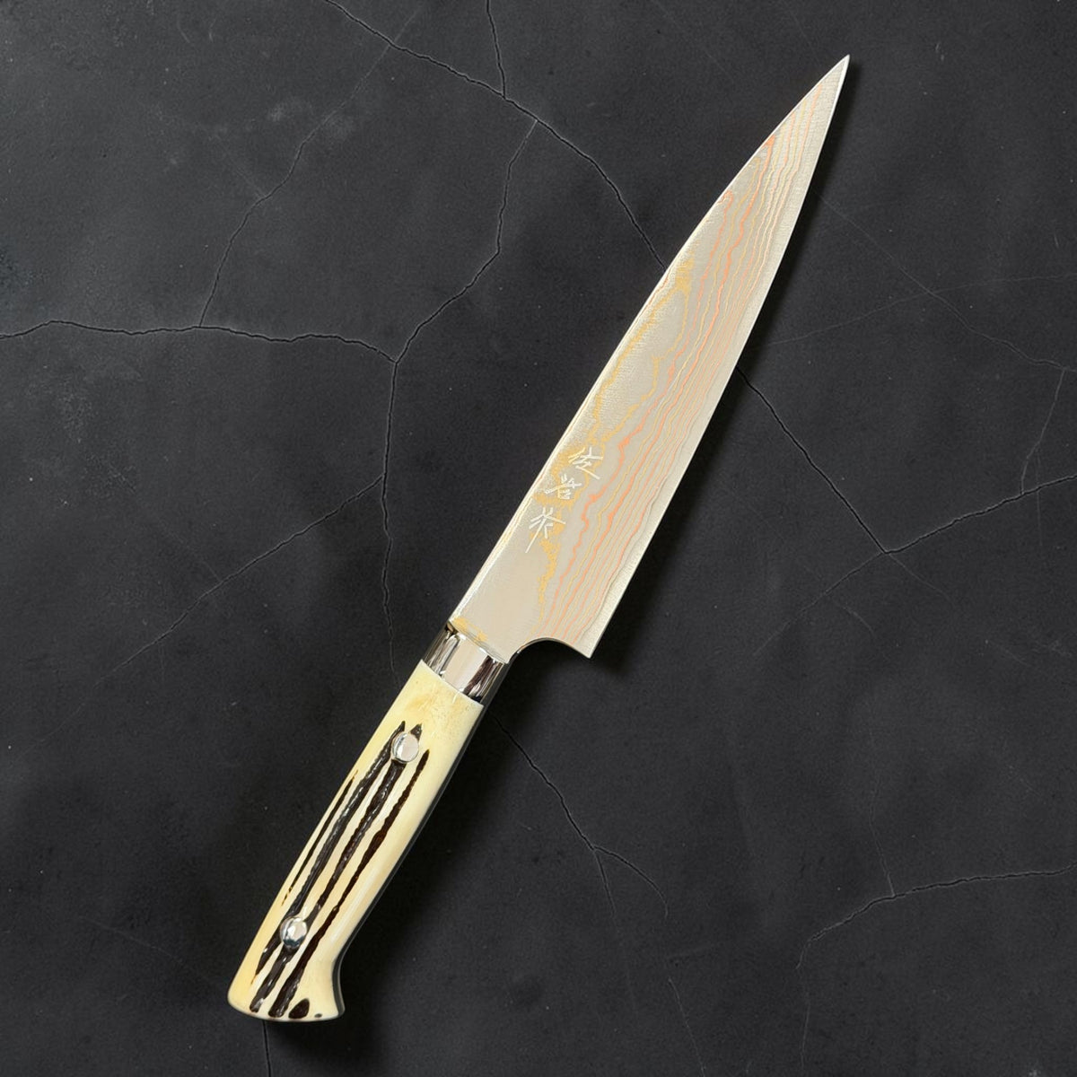 Hero of Takeshi Saji Blue #2 Rainbow Damascus Petty 150mm with white cow-horn western handle.