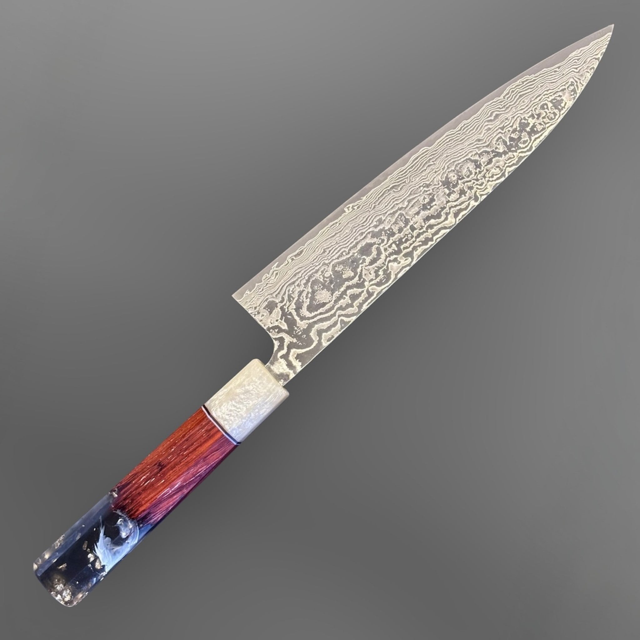 Takeshi Saji SG2 Kuro Damascus Gyuto 210 mm with Prisma Knife Handle, alternate angled product photo highlighting the damascus blade pattern and resin-and-wood Prisma handle.