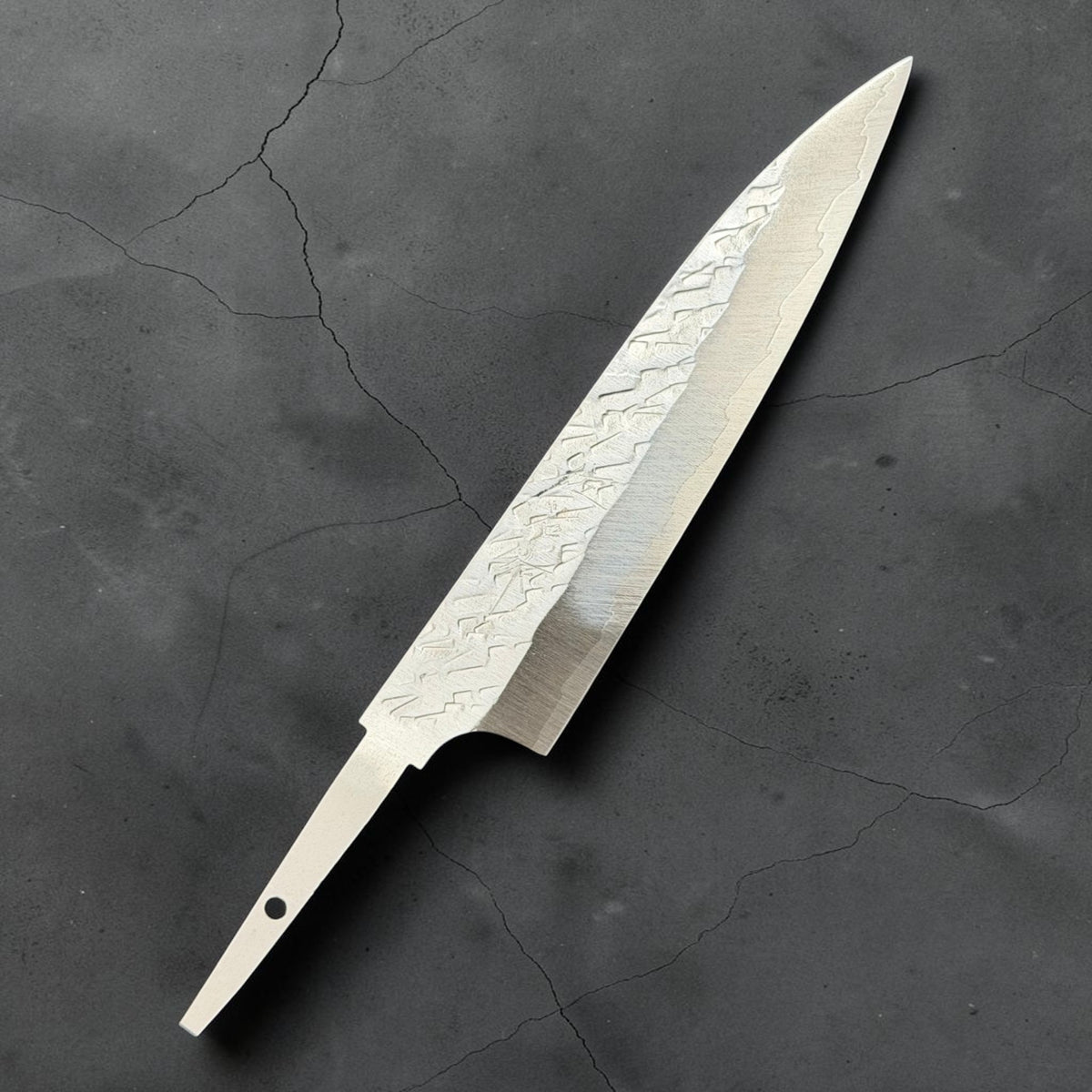Angled front view of Takeshi Saji STRIX Tsuchime Petty 130mm blade only, showing the hammered finish and exposed tang.