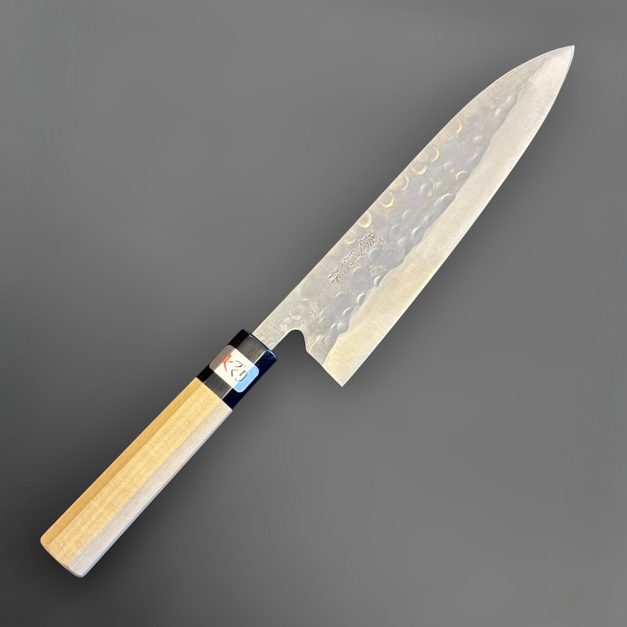 Teruyasu Fujiwara Maboroshi Gyuto 210mm with Magnolia and Buffalo Wa Handle, reverse three-quarter view showing the opposite blade face, kanji, and magnolia wa handle.