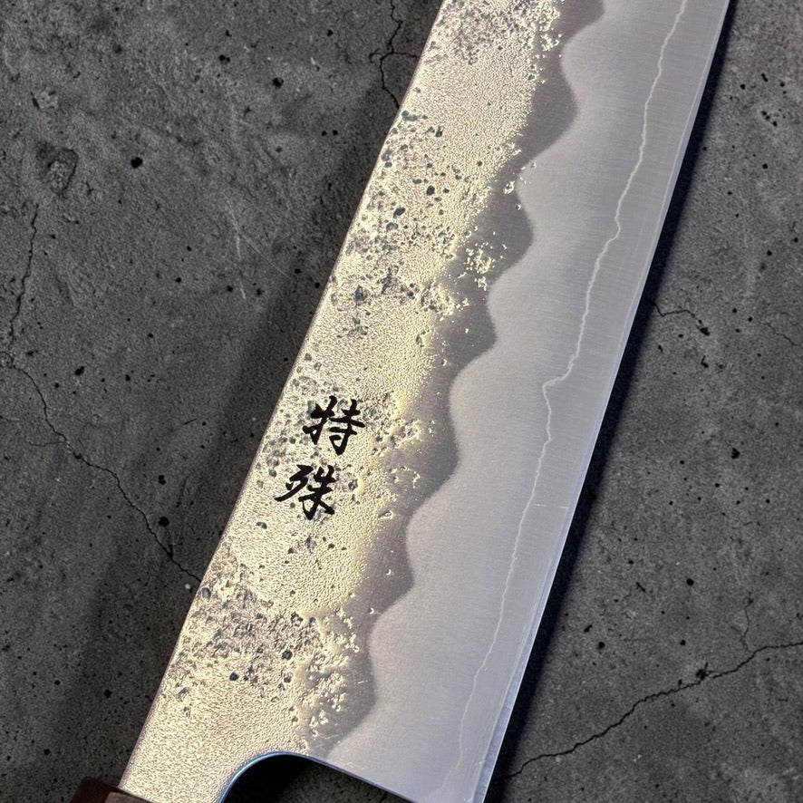 Close-up of Tokushu kanji, nashiji pear-skin finish, and cladding line on the Ginsan #3 Kiritsuke