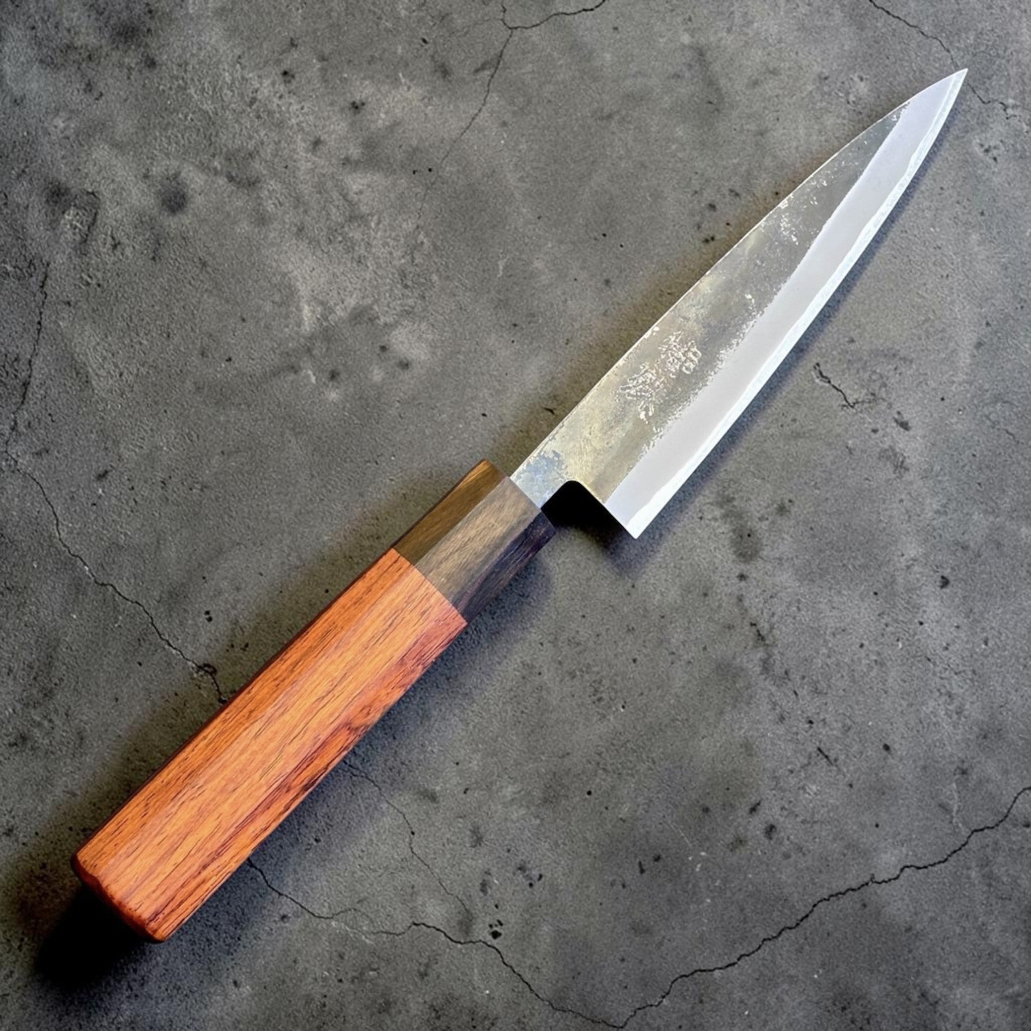 Tokushu Knife Rosewood Series White #2 Kurouchi 135 mm Japanese petty knife, angled front view showing kurouchi finish and rosewood wa handle.