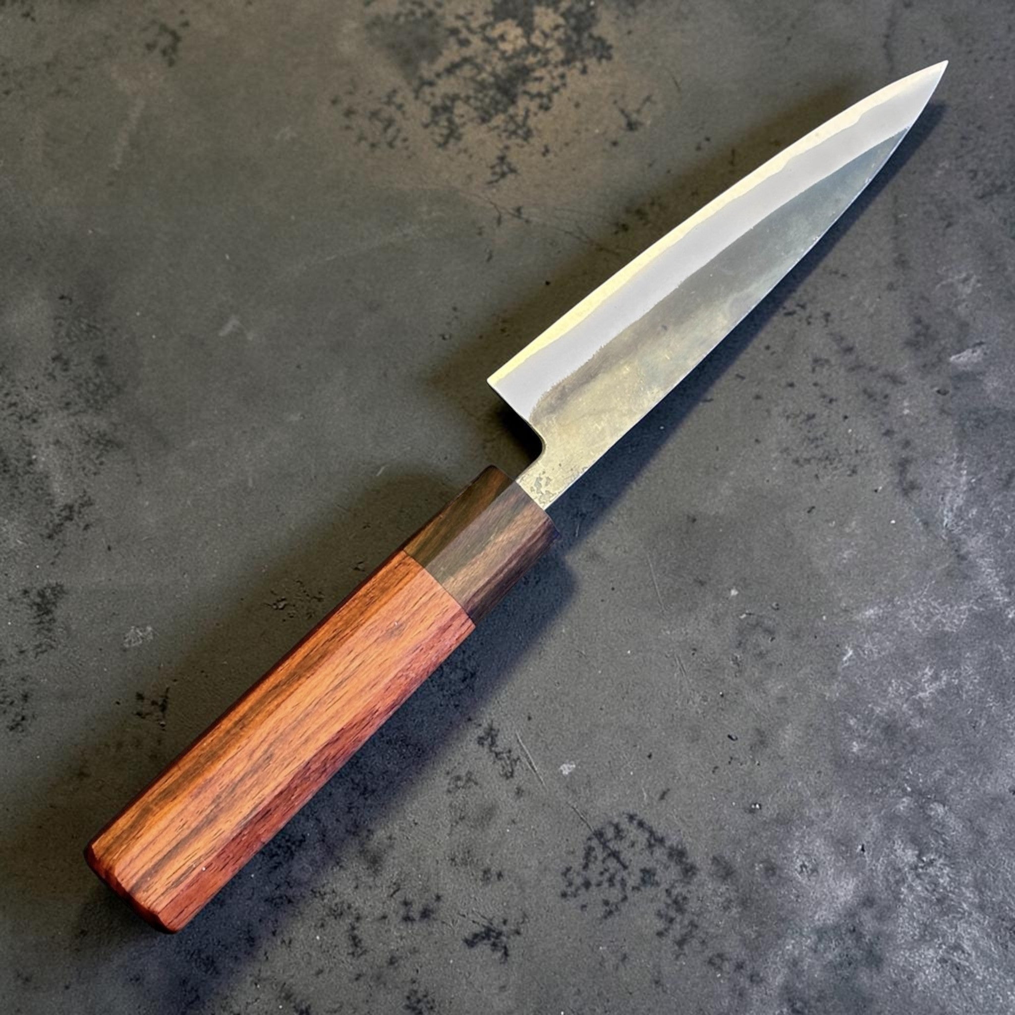 Tokushu Knife Rosewood Series White #2 Kurouchi 135 mm Japanese petty knife, angled reverse view with kurouchi blade finish and rosewood wa handle.
